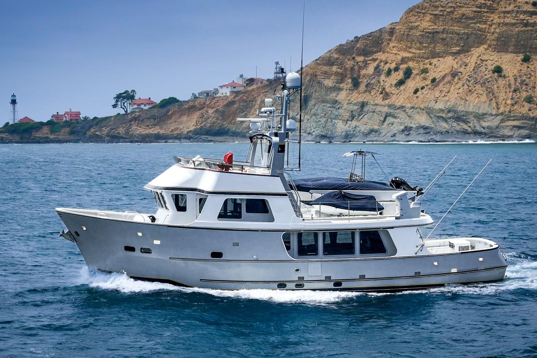 Seaton Long Range Cruiser 1990 navigating coastal waters with scenic cliffs in the background.