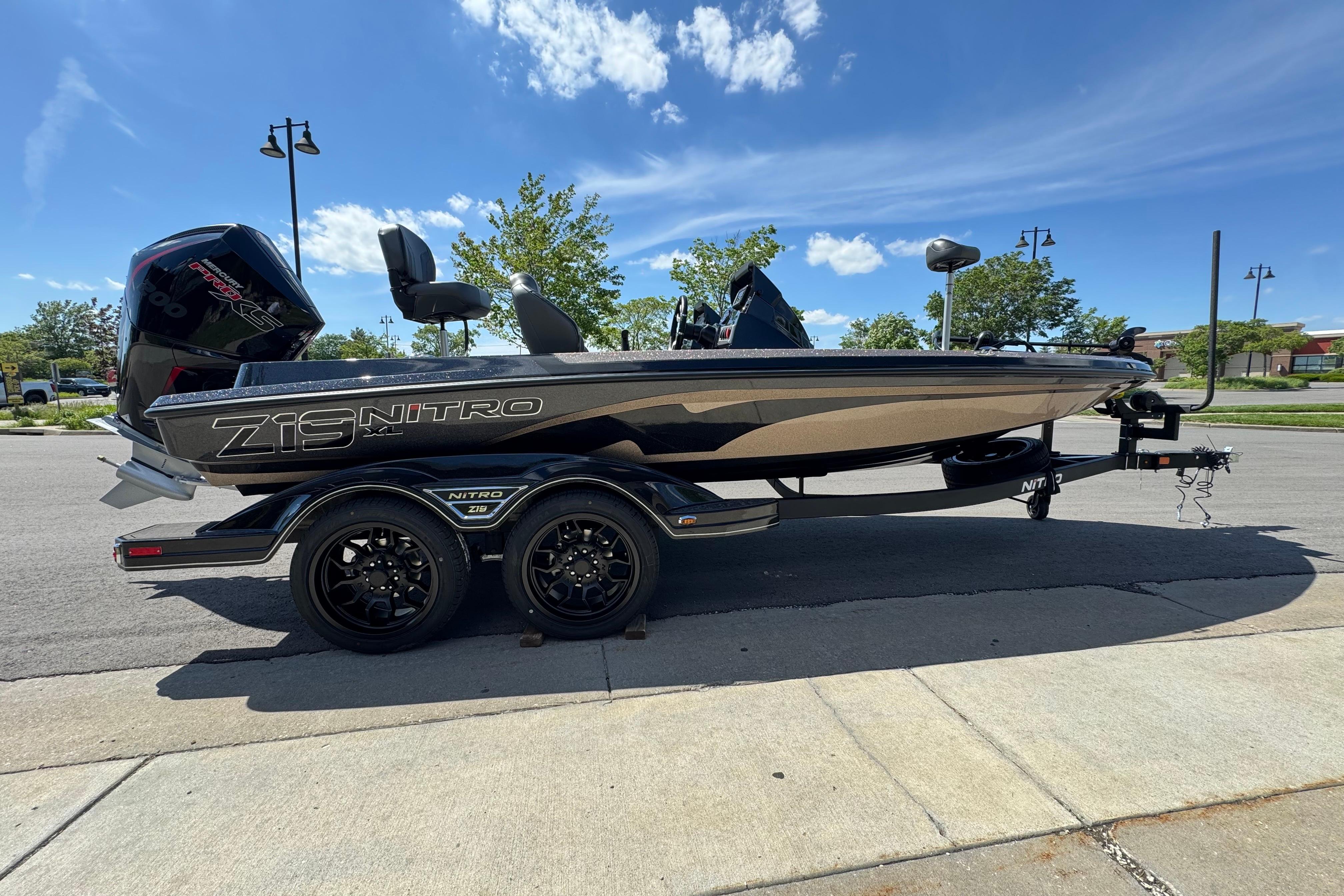 2026 Nitro Z19 XL boat on trailer, parked on street under clear blue sky.