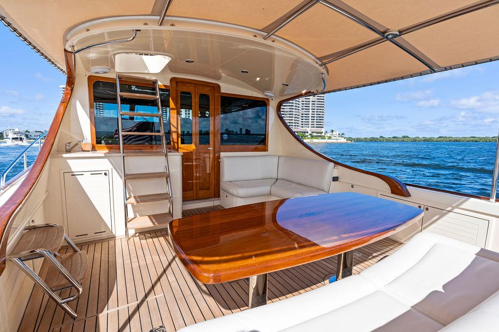 2018 Palm Beach Motor Yachts PB55 Flybridge with elegant deck and ocean view.