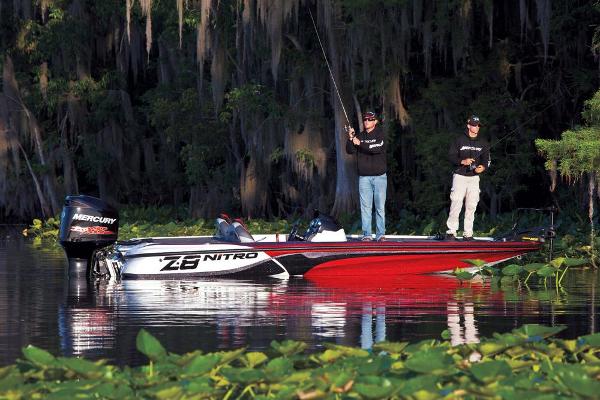 Manufacturer Provided Image: Two people fishing on a 2013 Nitro Z-8 boat in a lush, serene lake.