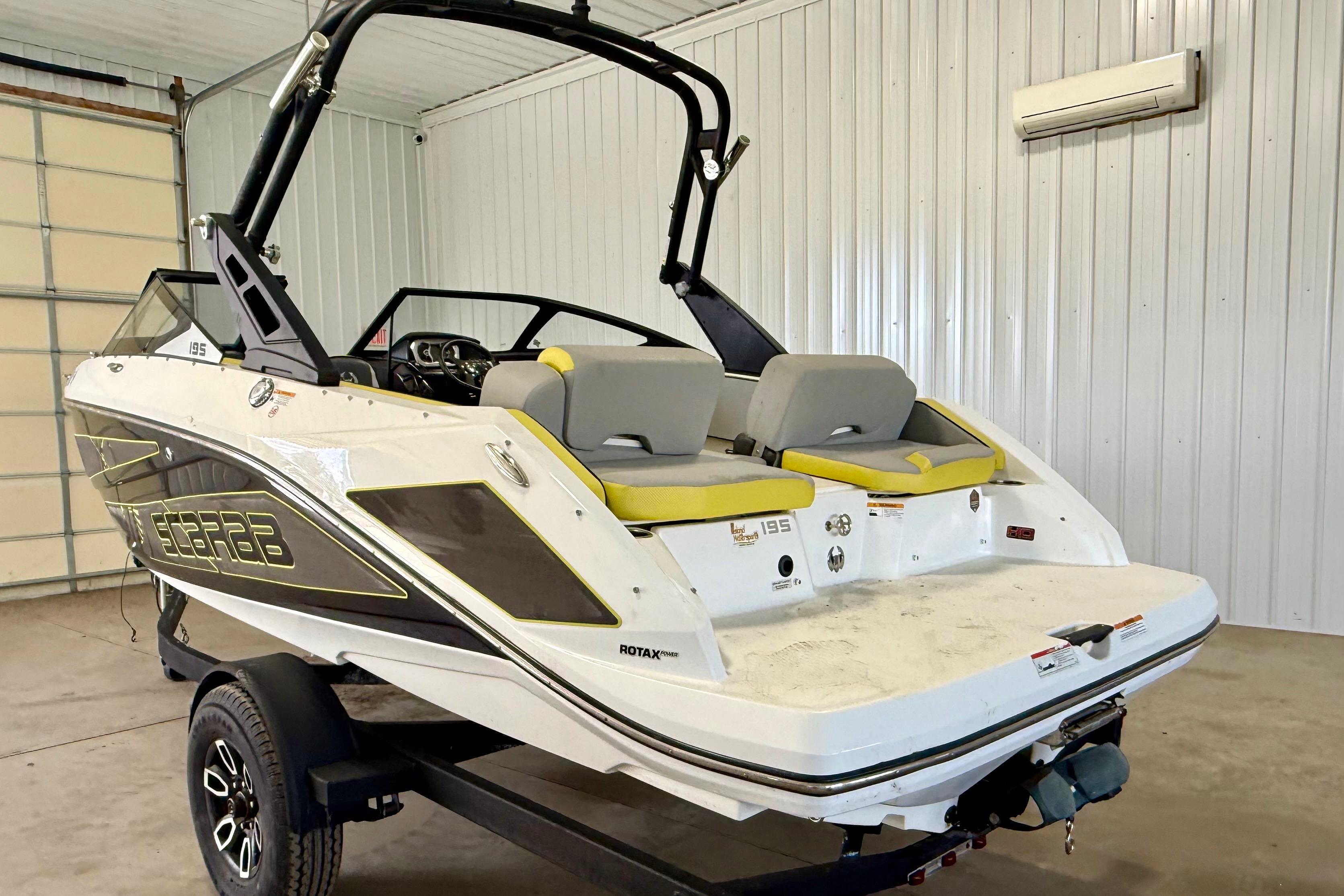 2023 Scarab 195 ID boat in a garage, showcasing sleek design and modern features.
