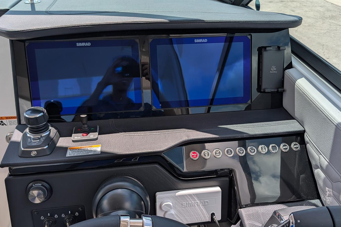 2026 Four Winns H33 OB boat dashboard with dual Simrad displays and control panel.