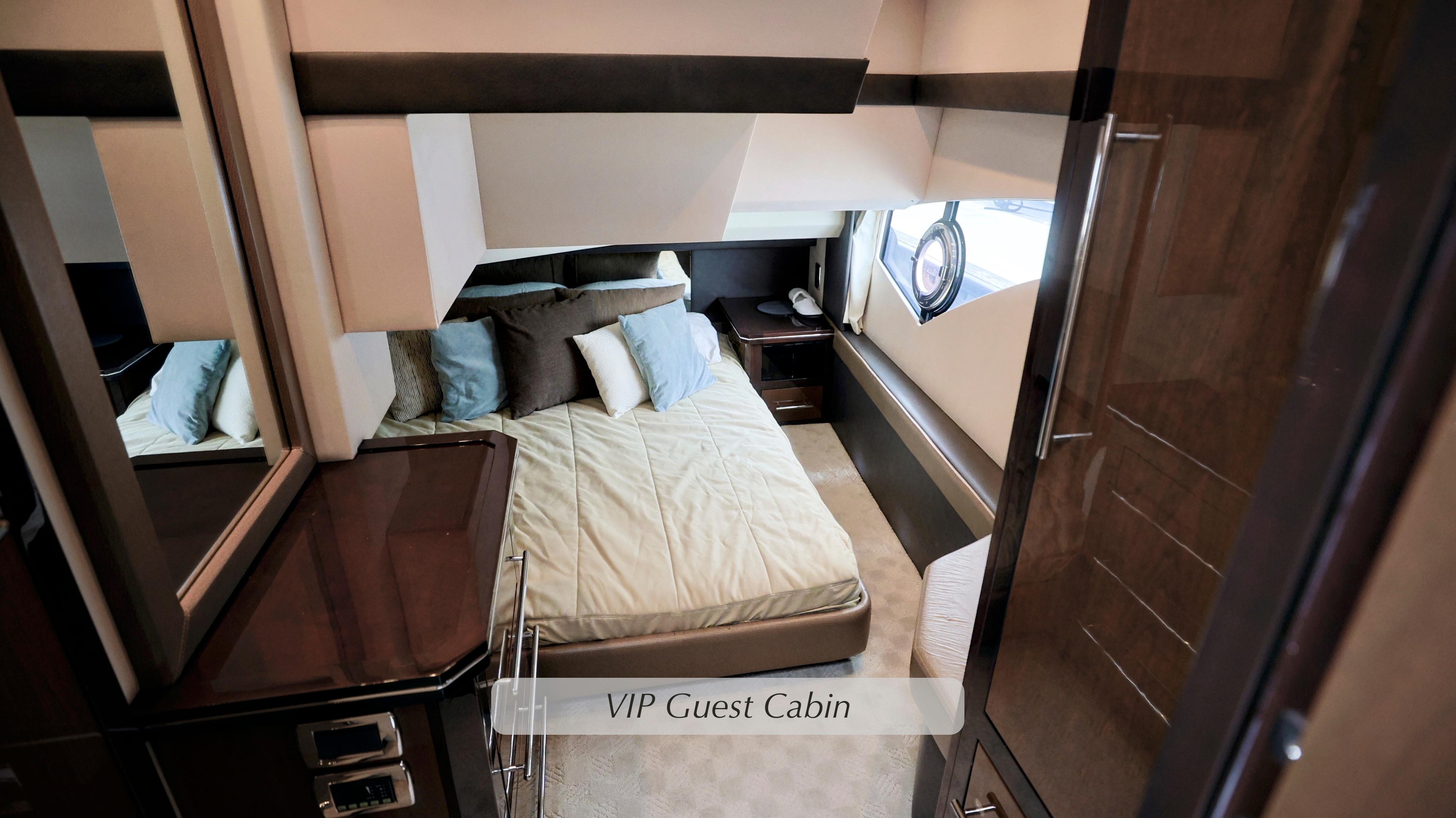 VIP guest cabin in 2013 Marquis 500 Sport Bridge yacht, featuring a cozy bed and elegant decor.