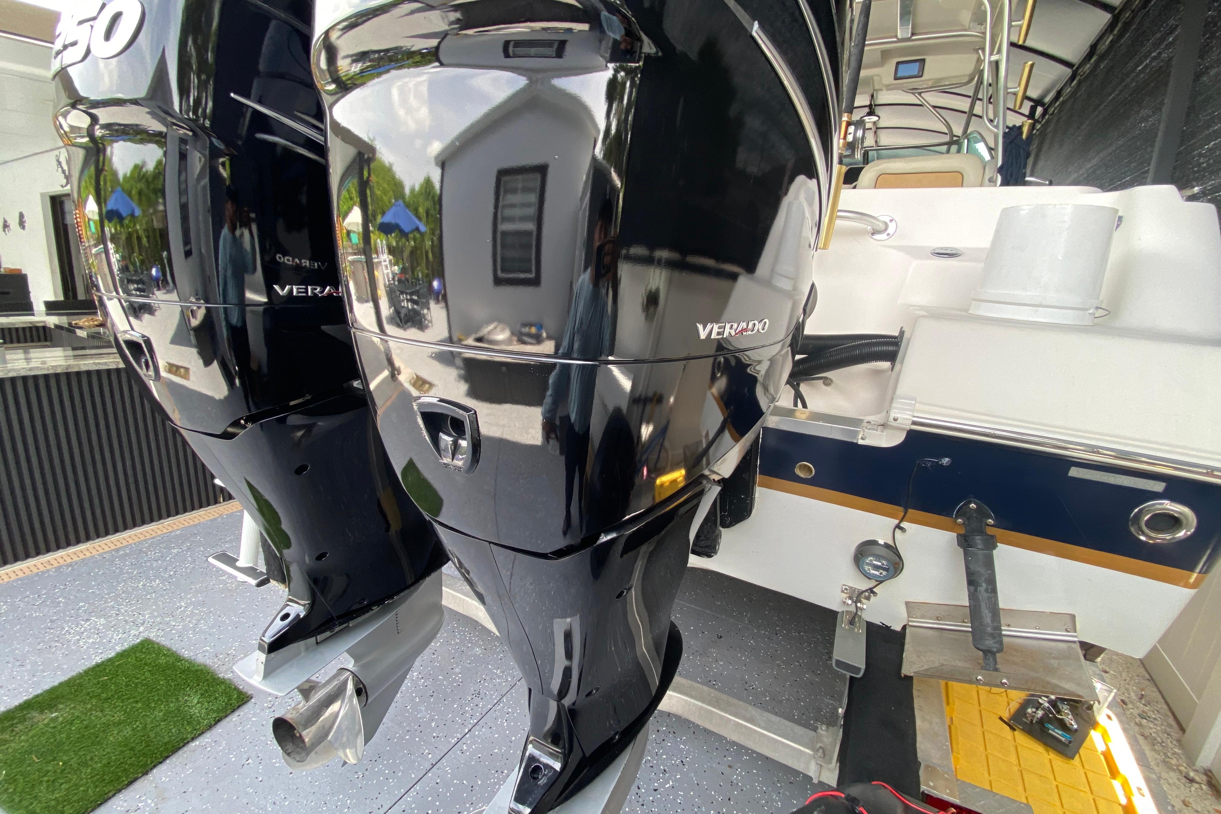 2005 Wellcraft 290 Coastal boat with dual Verado outboard engines, docked in a marina.
