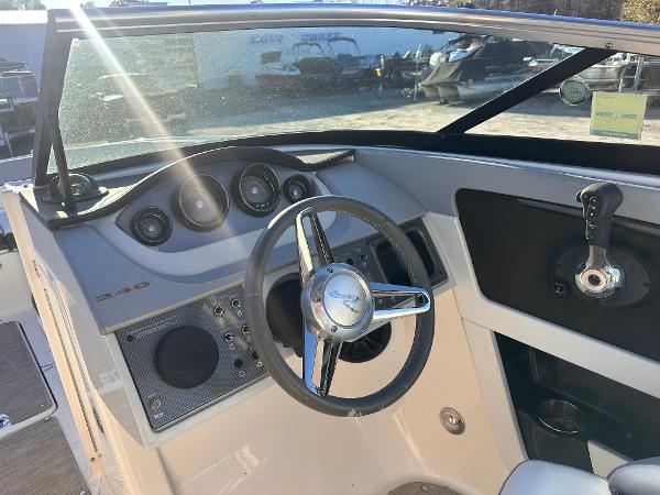 2016 Sea Ray 240 Sundeck boat dashboard with steering wheel and instrument panel.