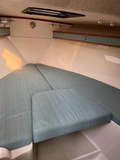 Interior of a 2002 Carolina Classic 25 boat with blue cushions.