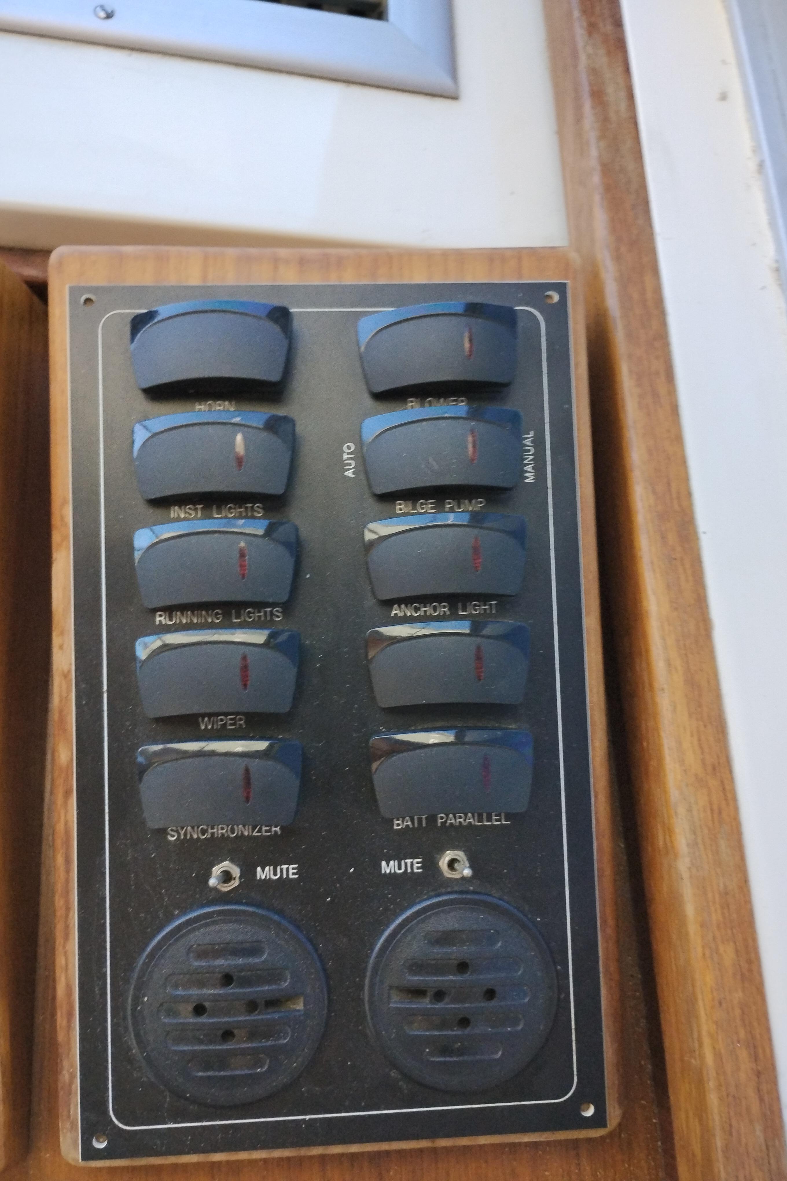 Control panel of a 1978 Bertram 33 Convertible boat with various switches and dials.