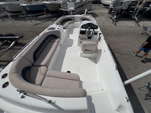 2014 Hurricane SunDeck Sport 232 OB boat with spacious seating and steering console.