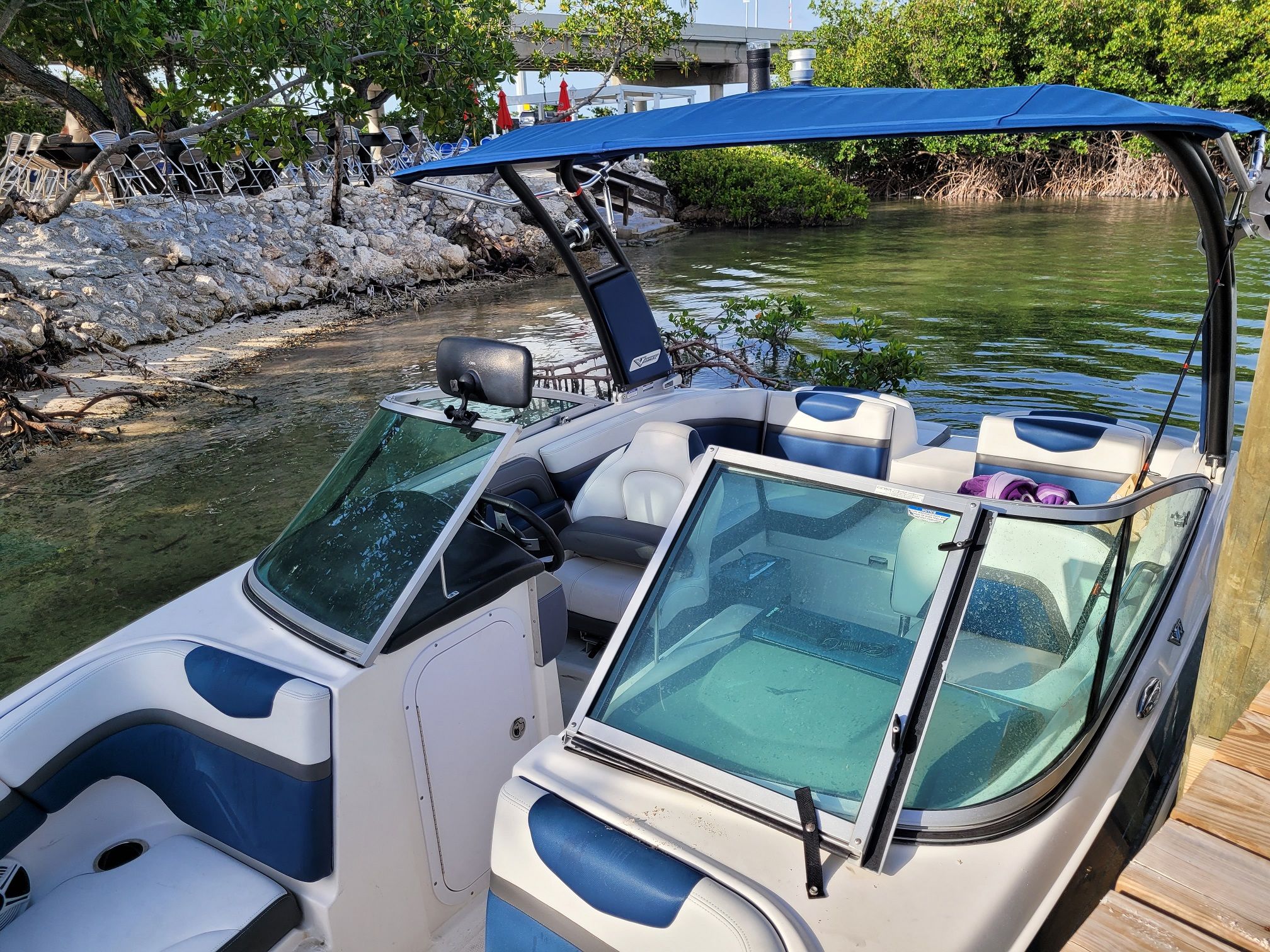 2015 Chaparral 203VR boat docked by the water.
