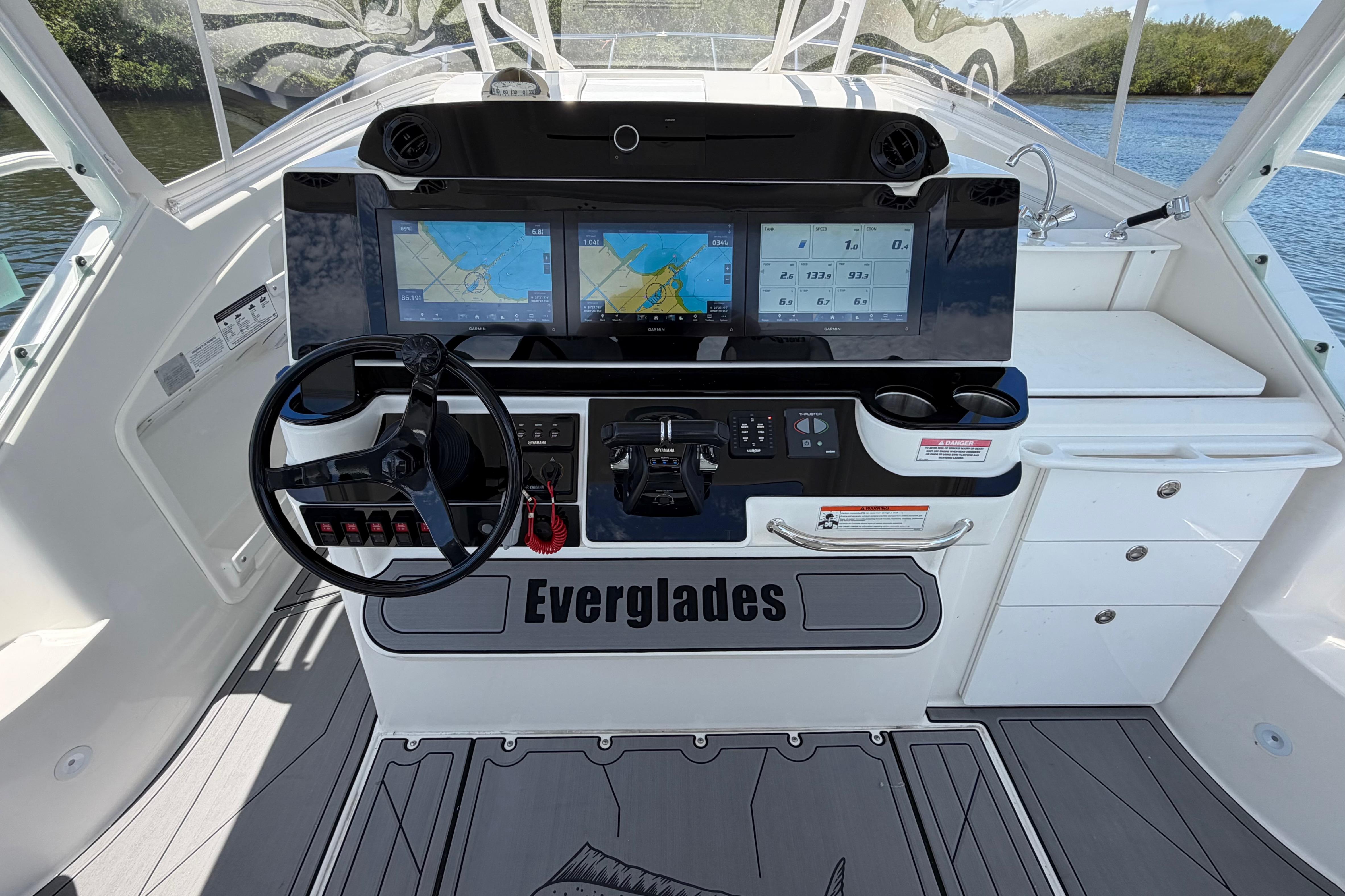 Cockpit of 2009 Everglades 350LX boat with dual navigation screens and steering wheel.