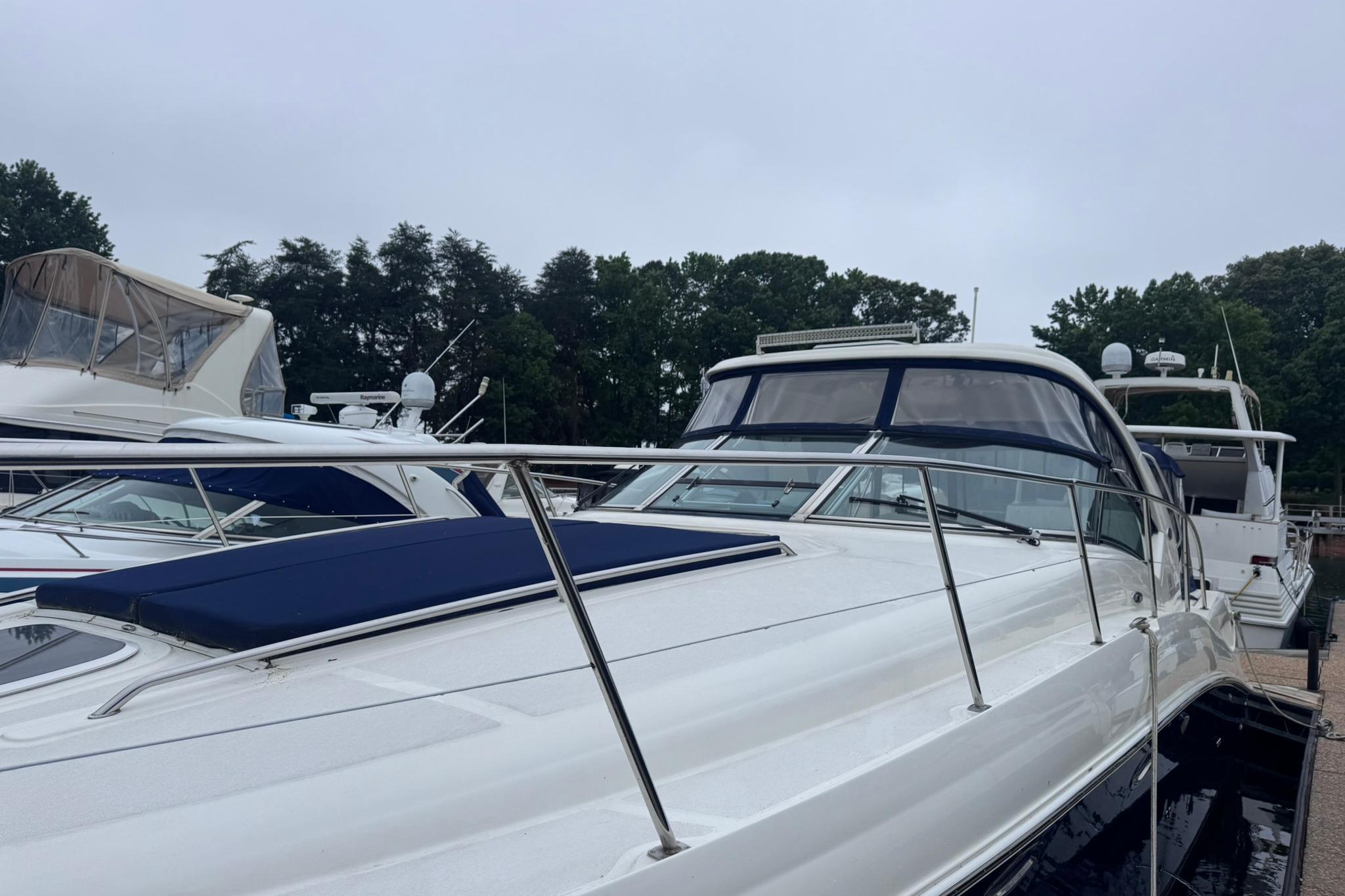 2004 Sea Ray 390 Sundancer yacht docked, featuring sleek design and spacious deck.