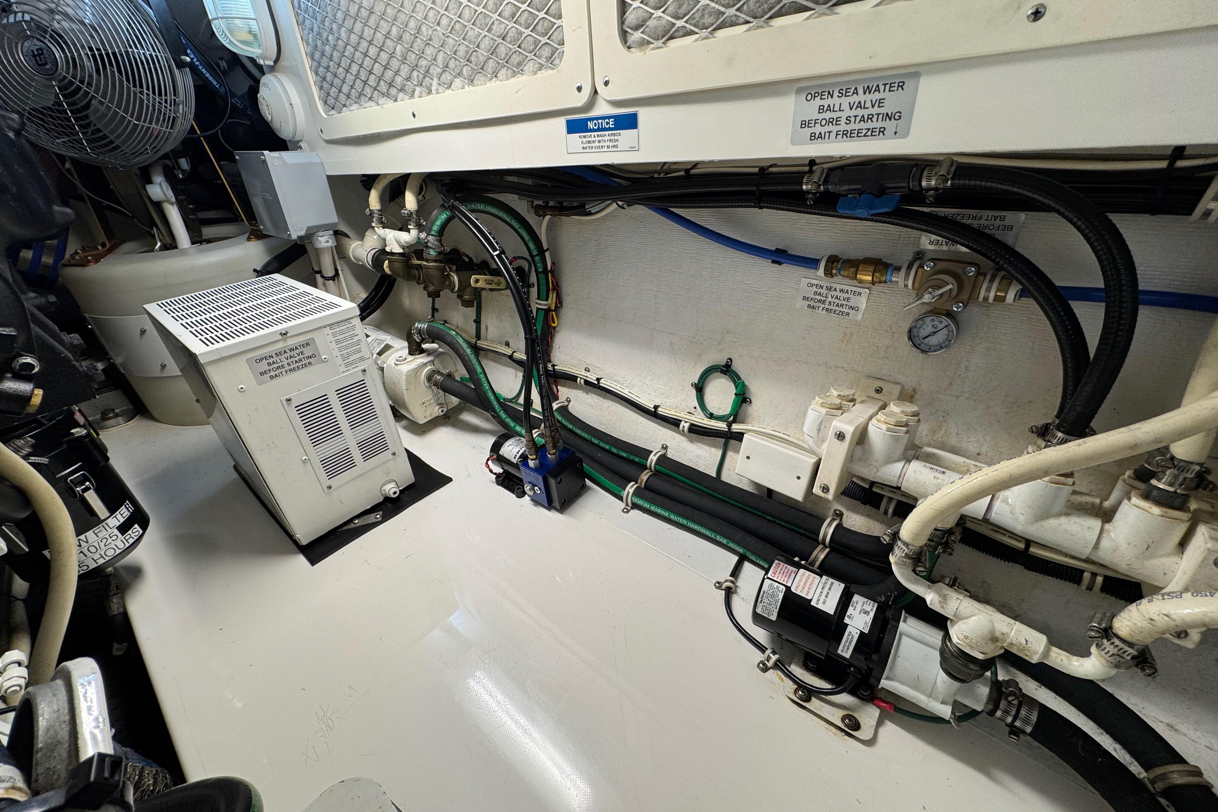 Engine room of 2013 Cabo 44 Hardtop Express with various mechanical components and wiring.