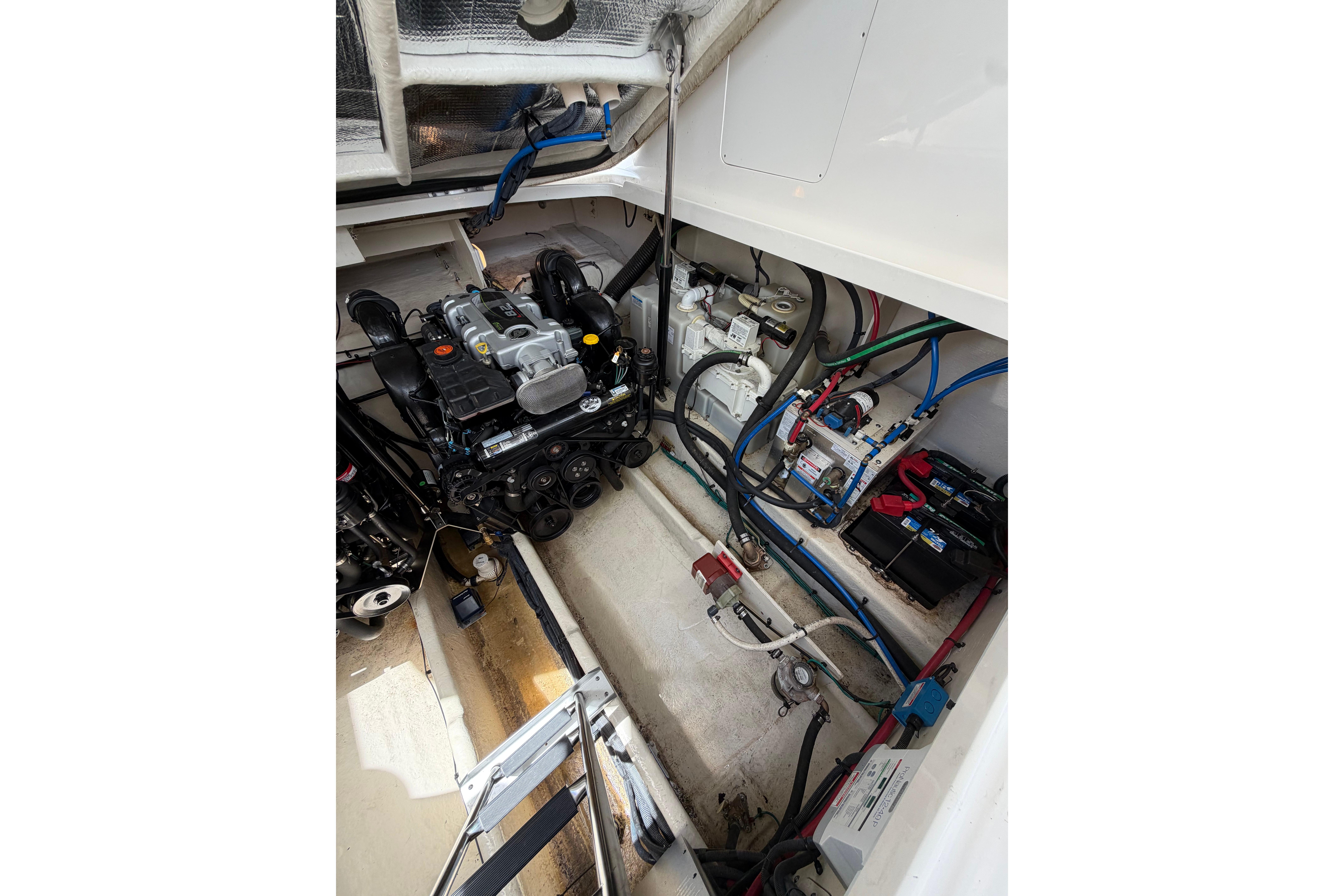 Engine compartment of 2012 Sea Ray Sundancer 370, showcasing mechanical components and wiring.