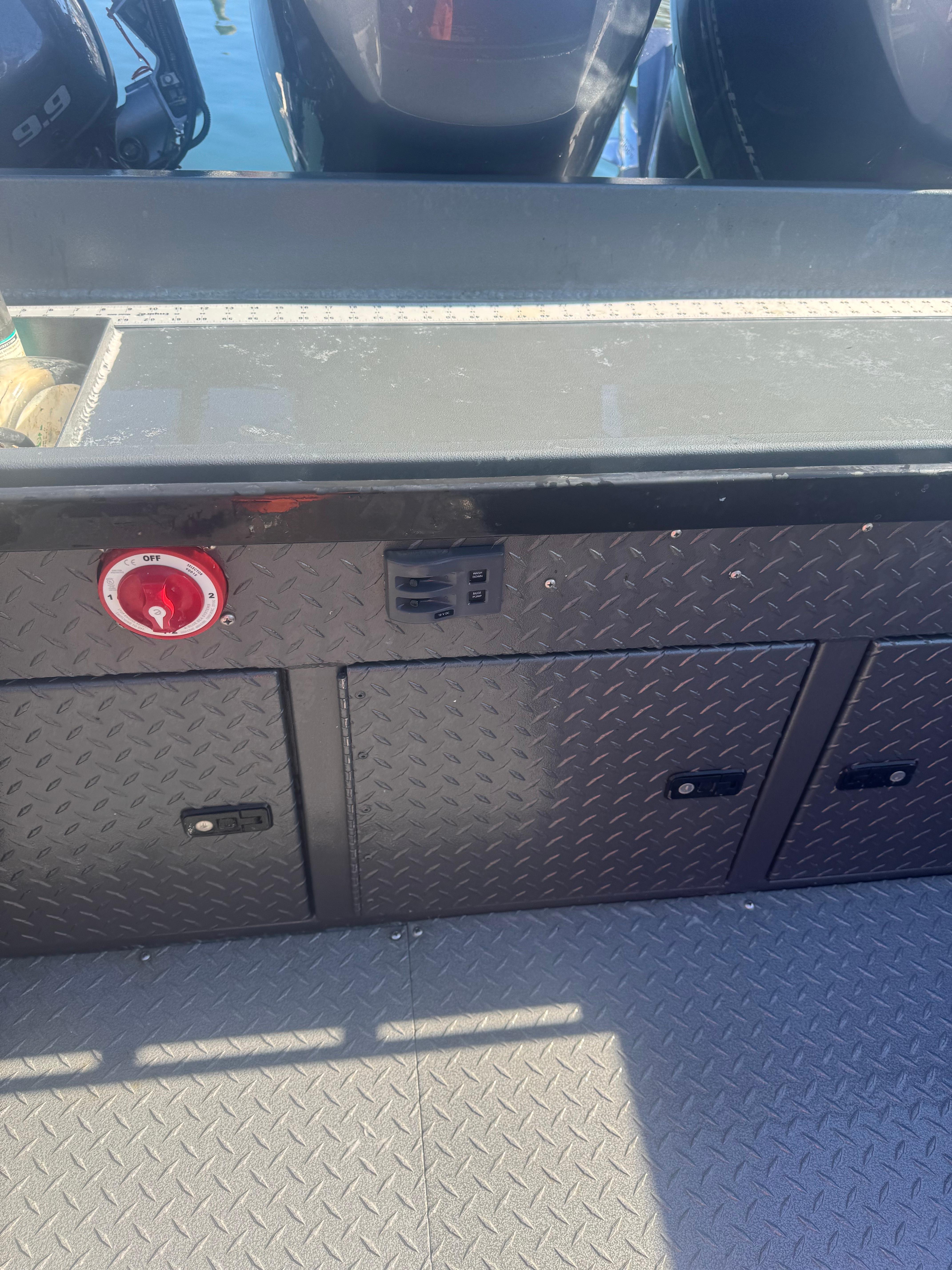 Custom Umpqua Marina 26 Bay Series 2022 boat deck with storage compartments and control panel.