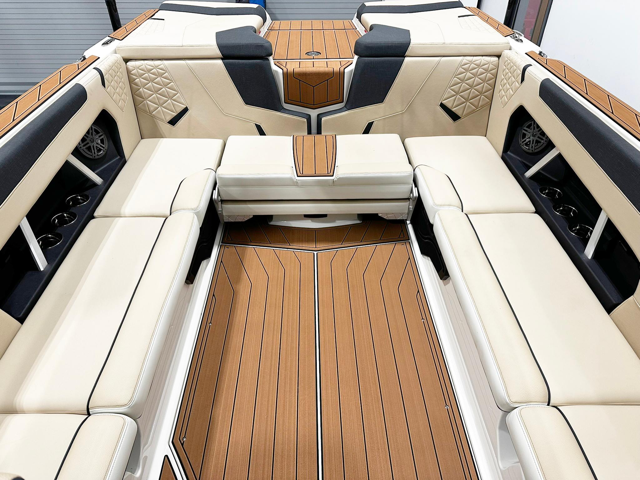 2026 Nautique GS24 boat interior with luxurious seating and wood accents.