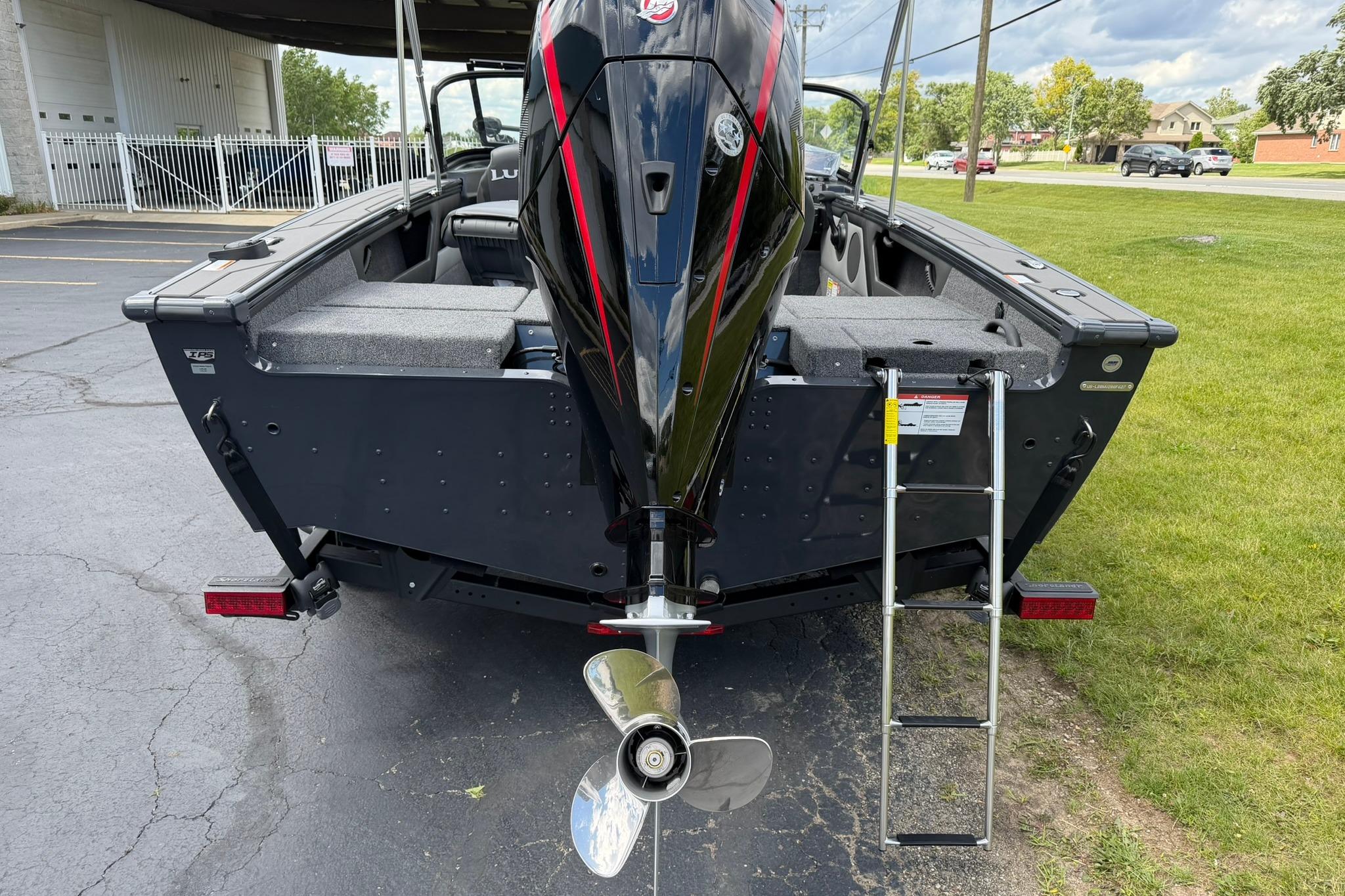 2027 Lund 1875 Crossover XS boat rear view with motor and ladder.