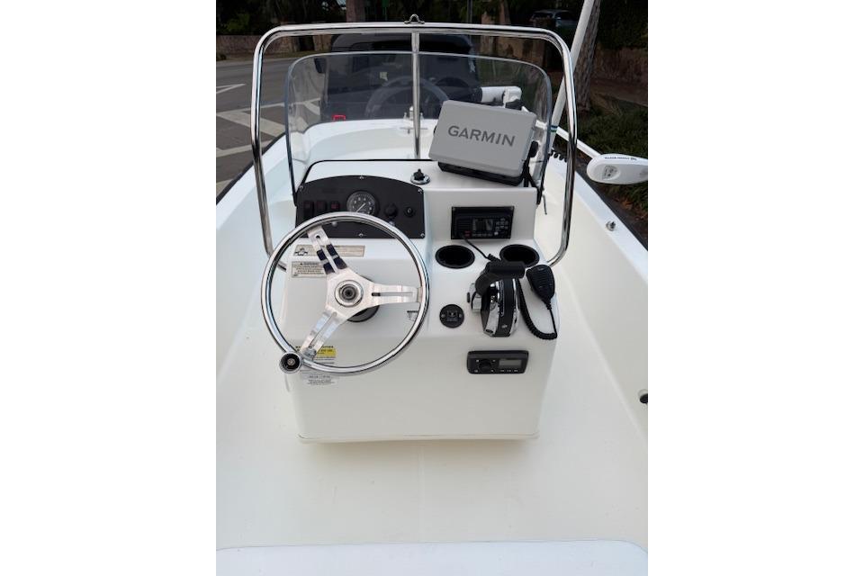 2016 Boston Whaler 150 Montauk boat console with Garmin GPS and steering wheel.