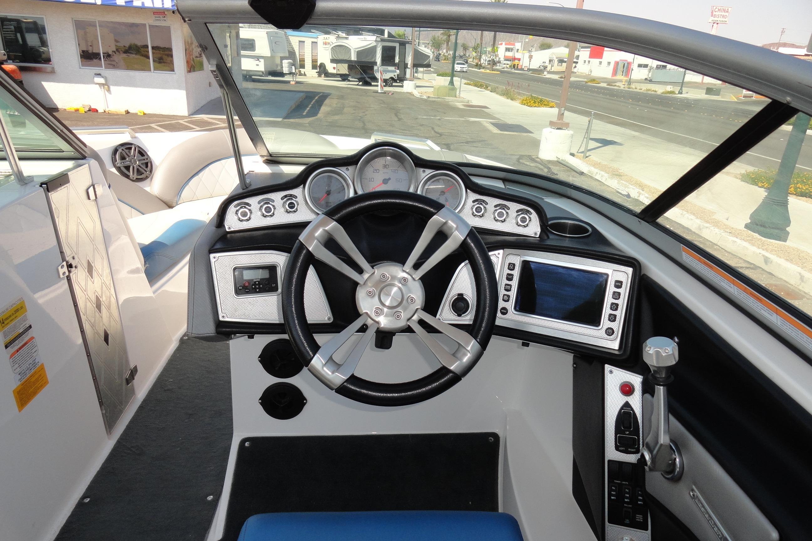 2013 MasterCraft X-10 boat dashboard with steering wheel and control panel.