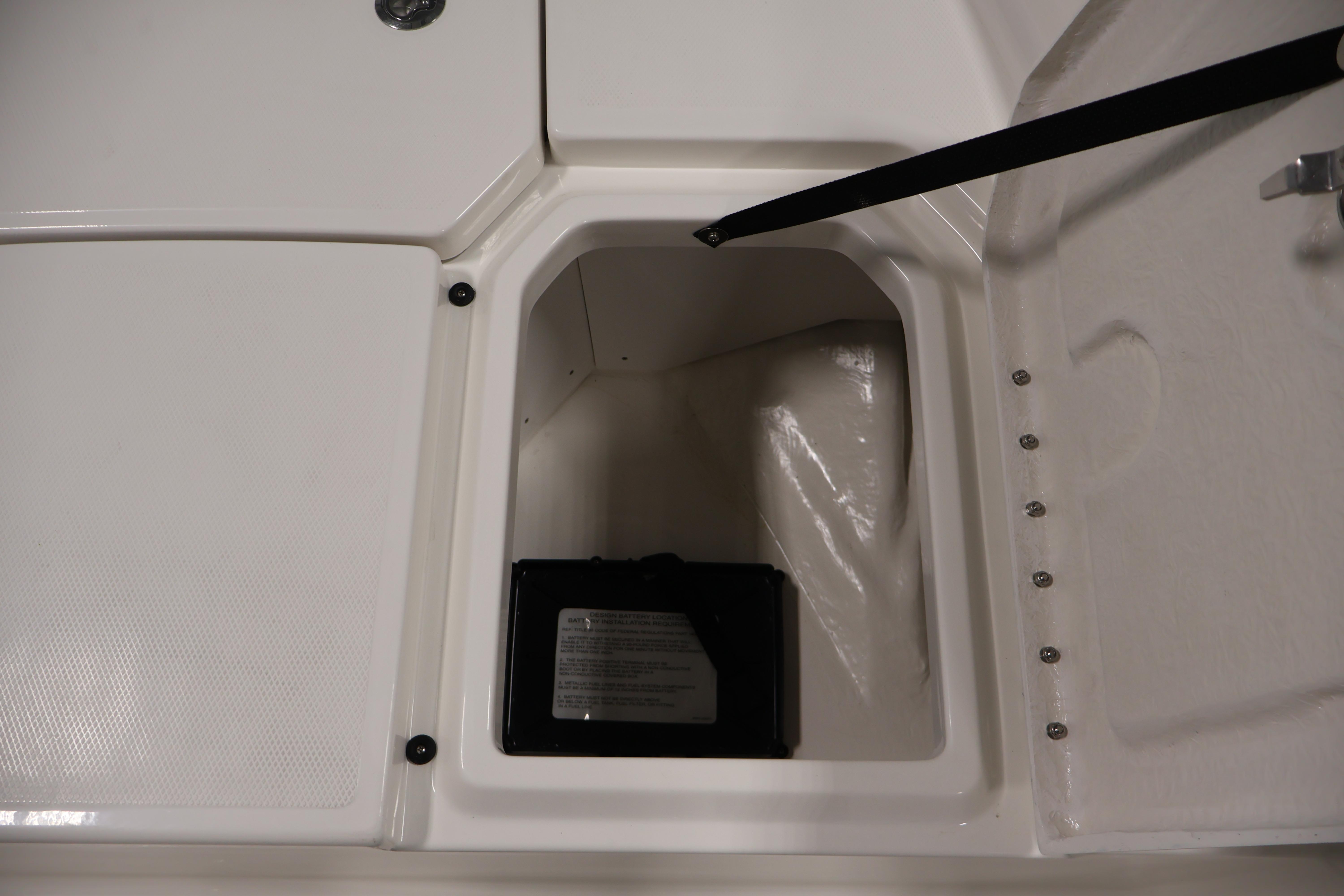Battery compartment of 2026 Bayliner Trophy T18 boat, featuring secure storage space.