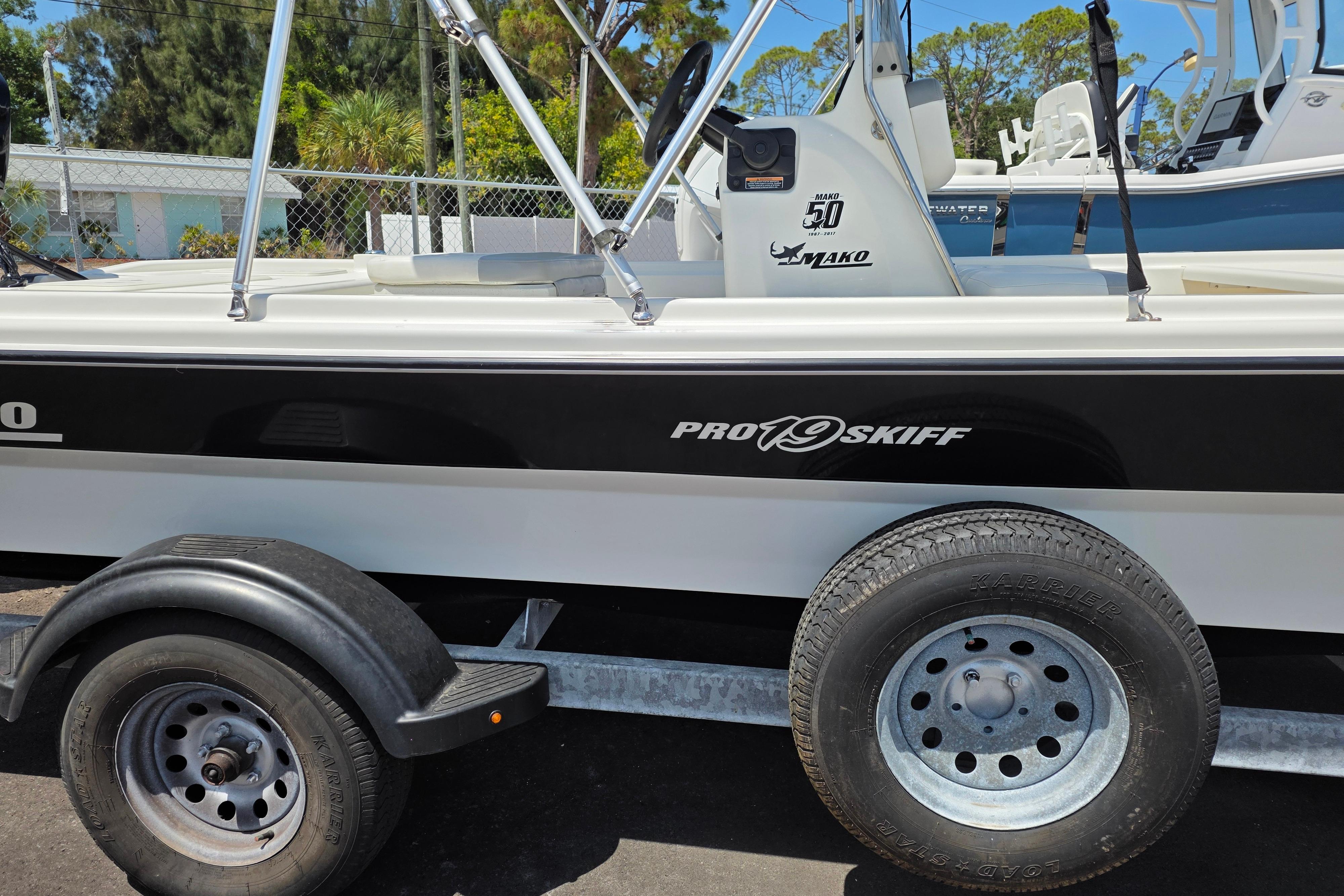2018 Mako Pro Skiff 19 CC boat on trailer, side view.