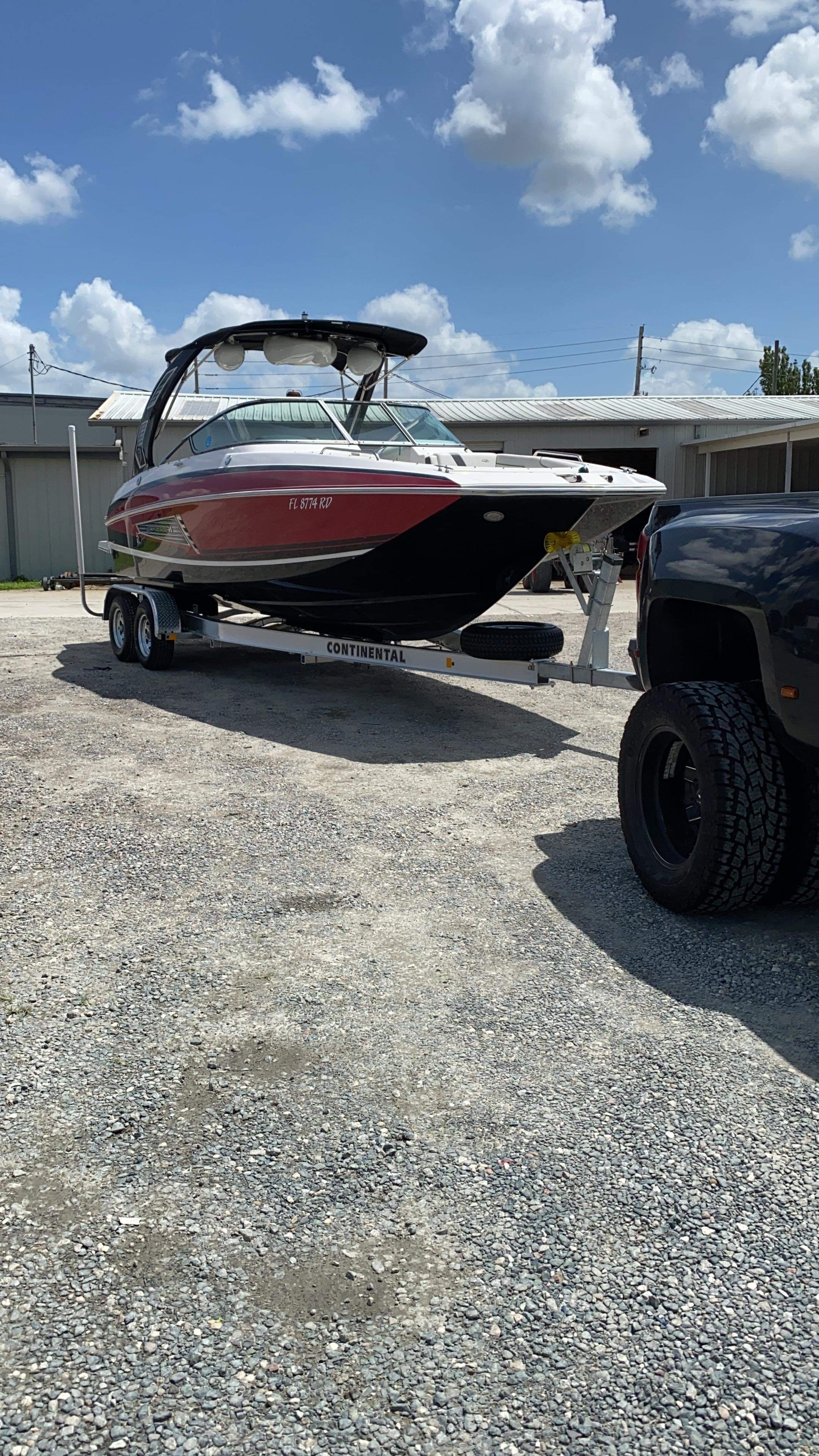 2016 Regal 27 FasDeck boat on trailer in sunny weather.