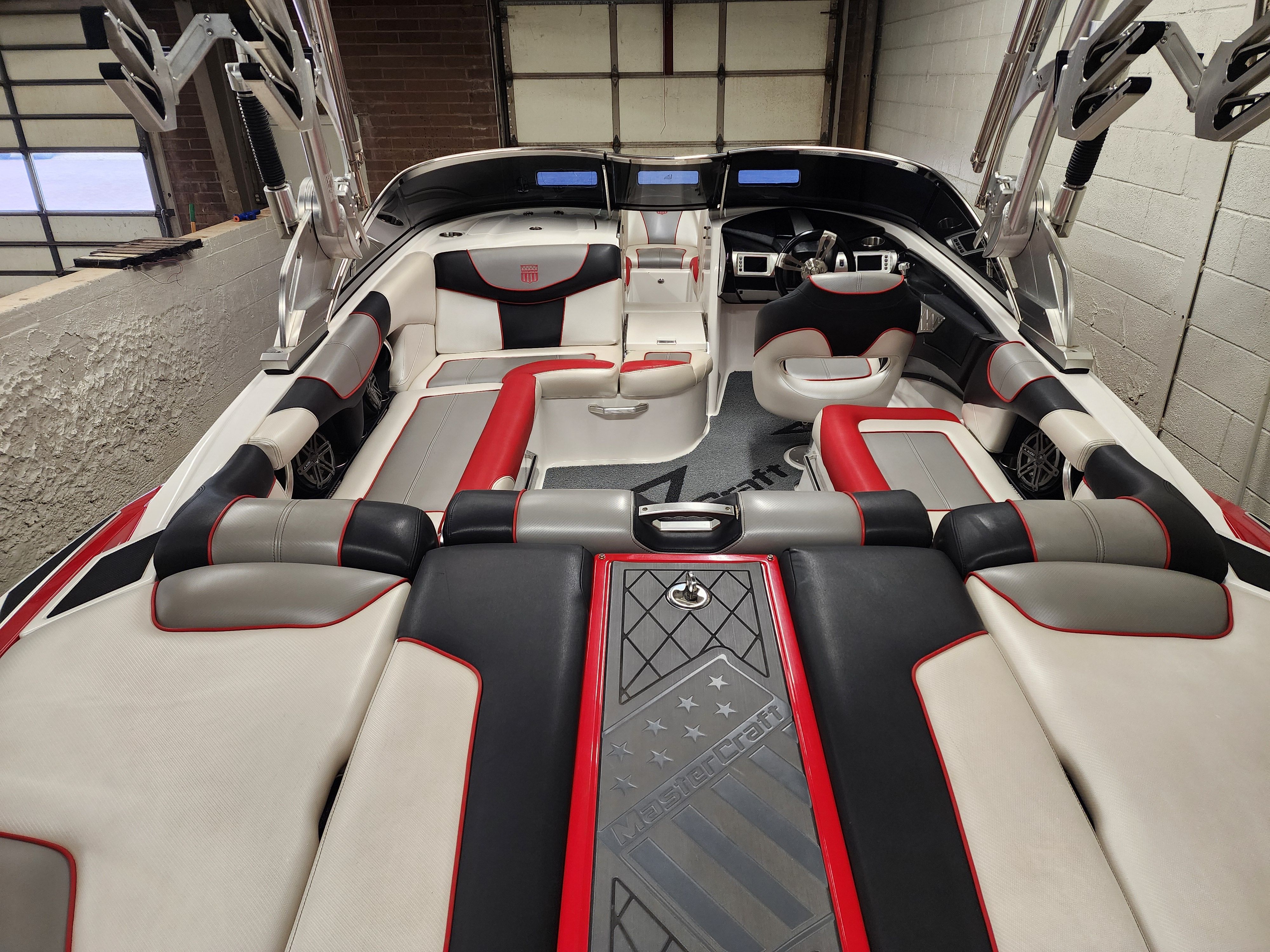 Interior of a 2013 MasterCraft XStar boat with luxurious upholstery.