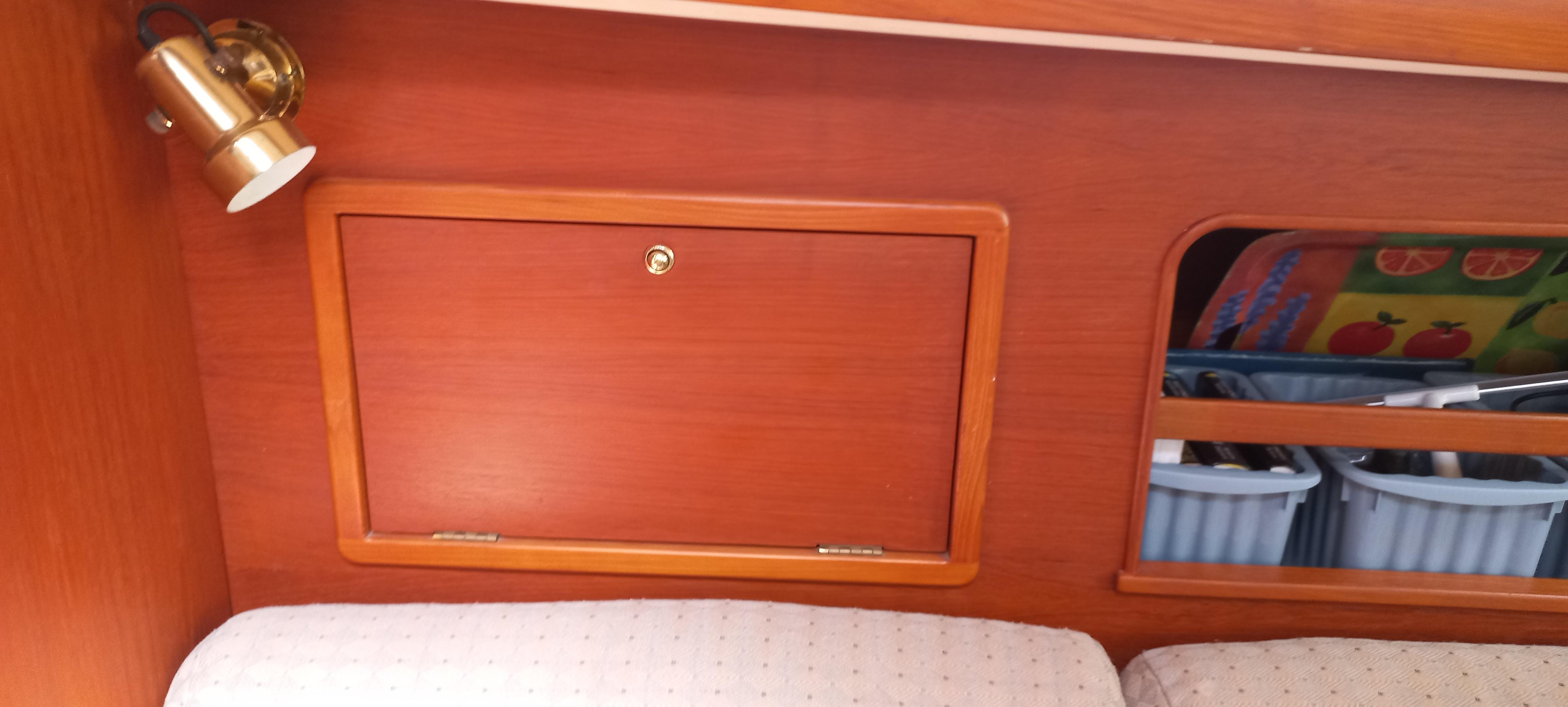 Interior of 1998 Nonsuch 33 sailboat with wooden cabinetry and storage compartments.