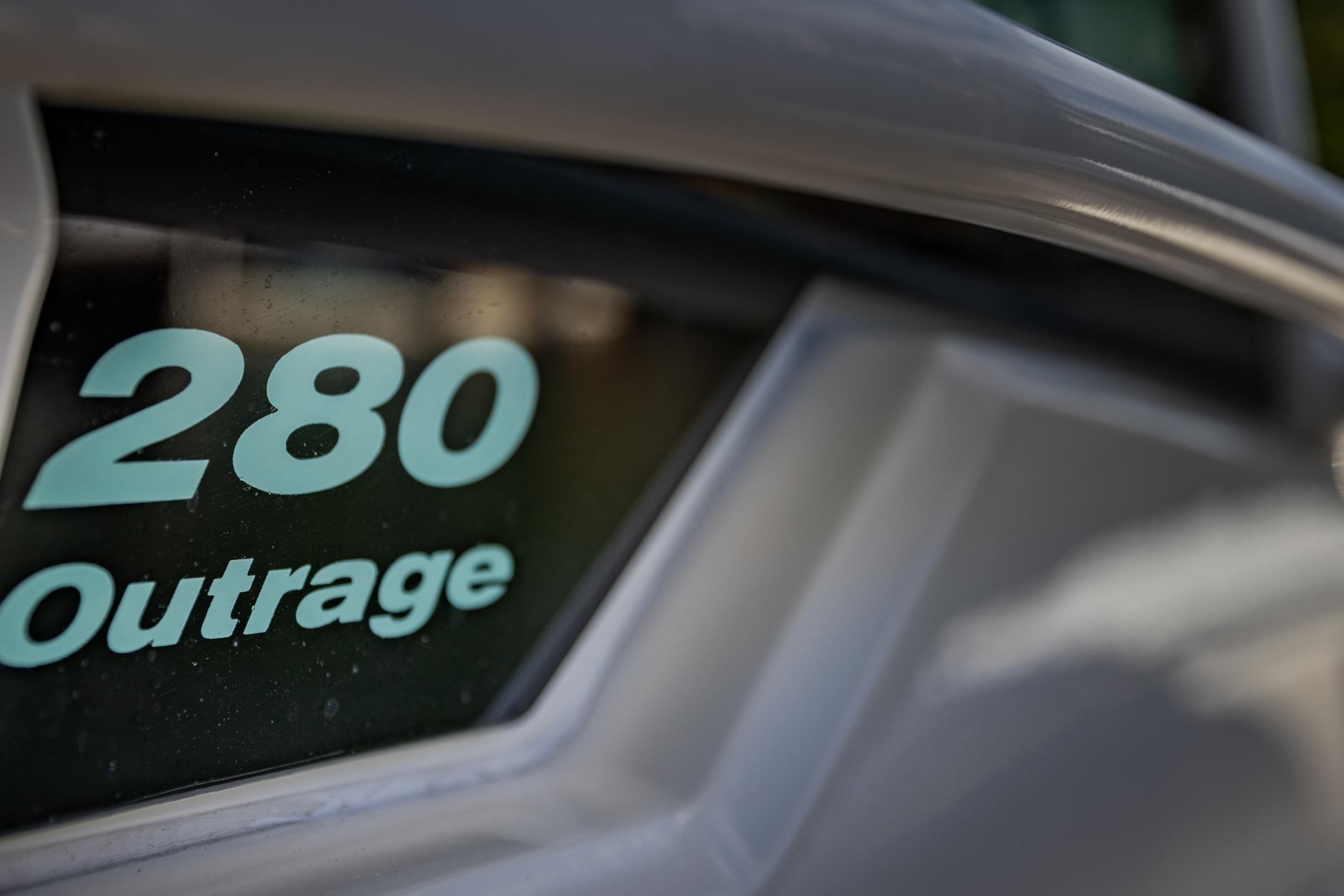 Close-up of 2016 Boston Whaler 280 Outrage boat model name on hull.