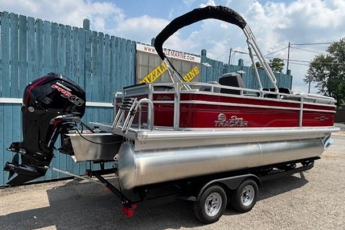 2026 Sun Tracker SportFish 20 DLX pontoon boat on trailer, featuring a powerful outboard motor.