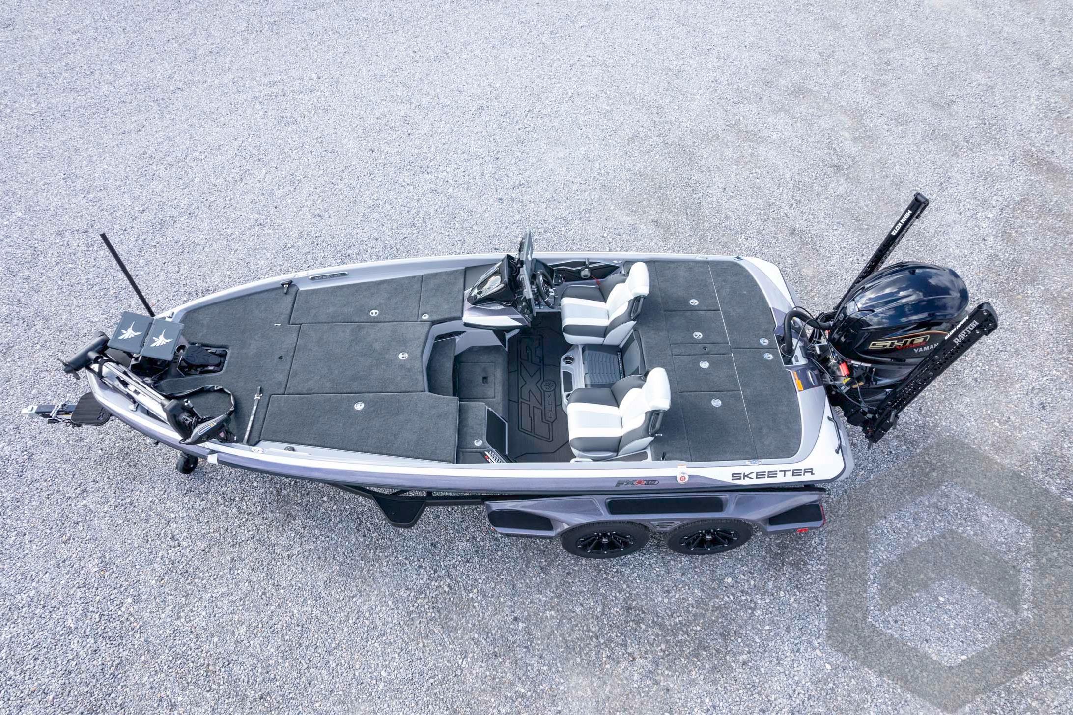 2026 Skeeter FXR20 FLEX fishing boat, aerial view, on gravel surface.