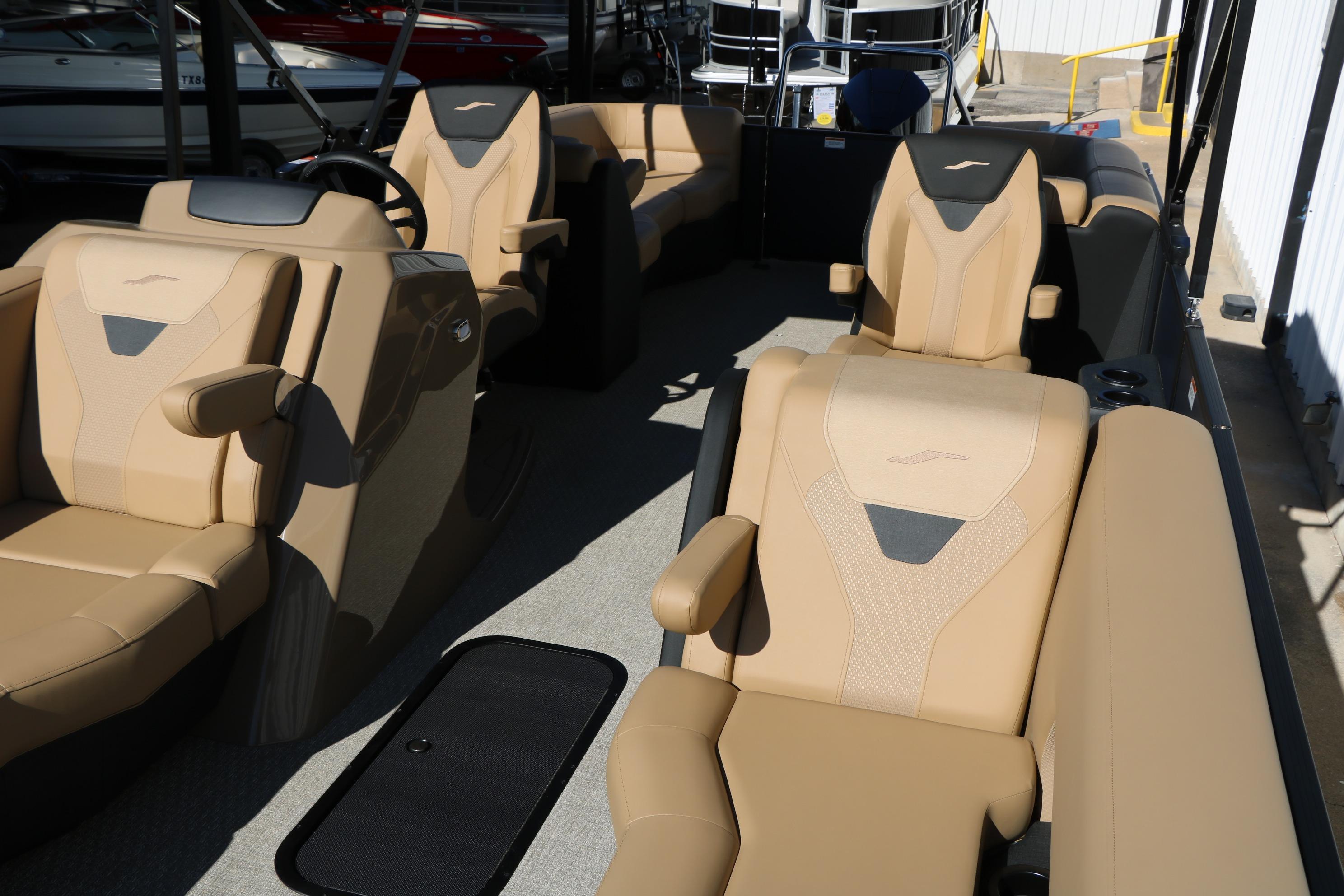 Luxurious interior of 2026 Evotti 525 QL Tri-Toon boat with beige seating.