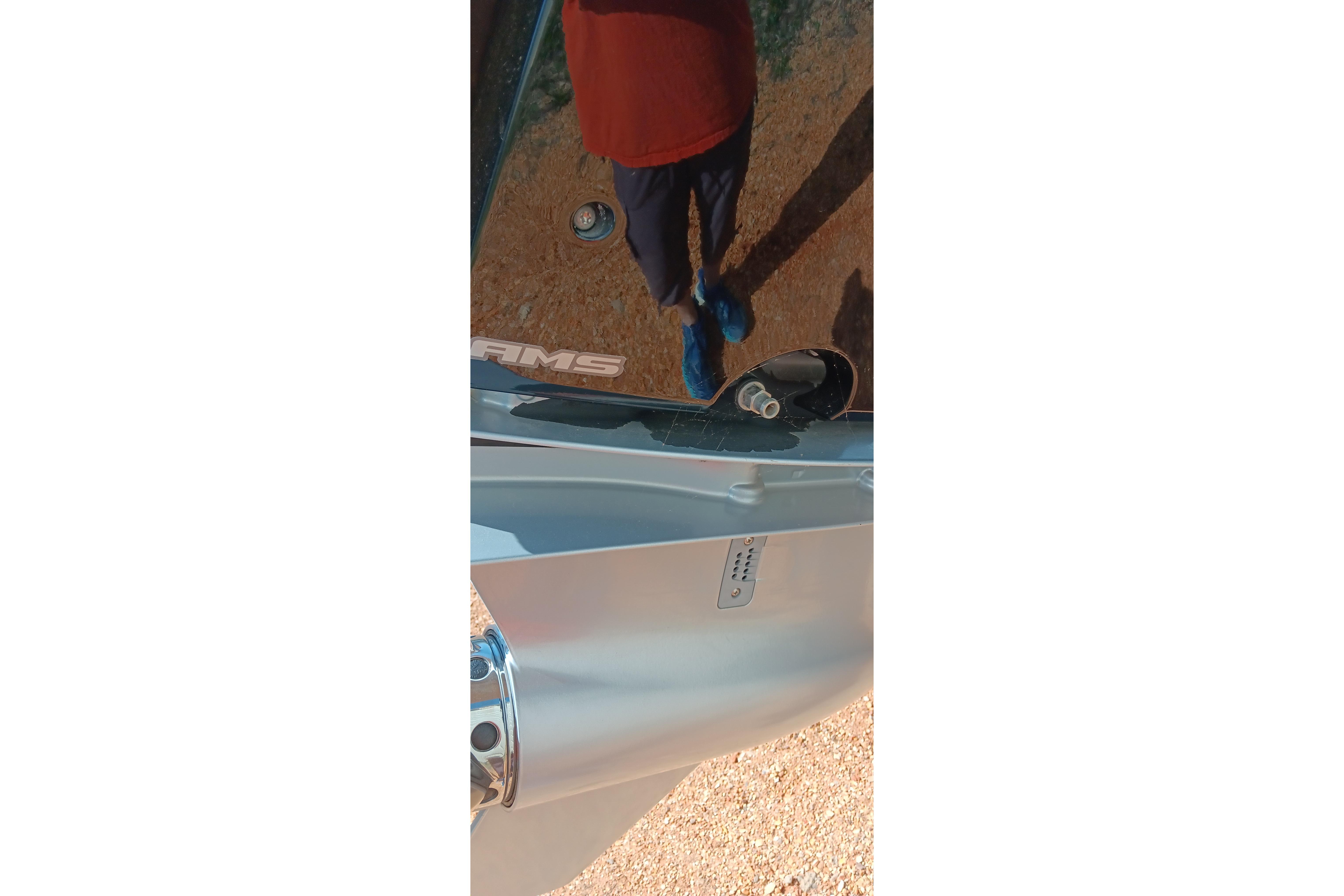 Reflection on Ranger 2500LS boat surface, showing person and surroundings, 2023 model.
