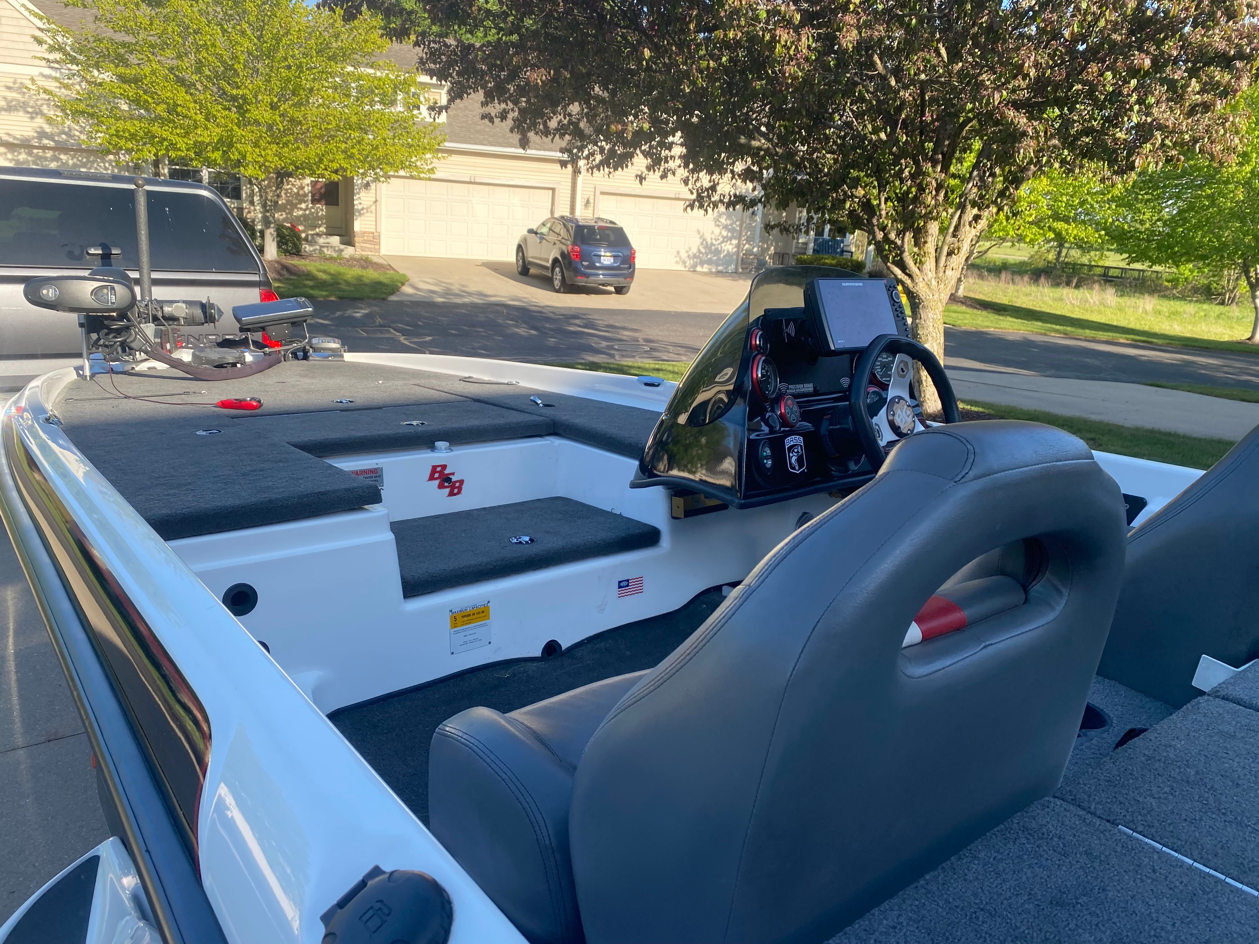 The image shows a 2014 Bass Cat Pantera II boat. It features gray seats and a modern cockpit.