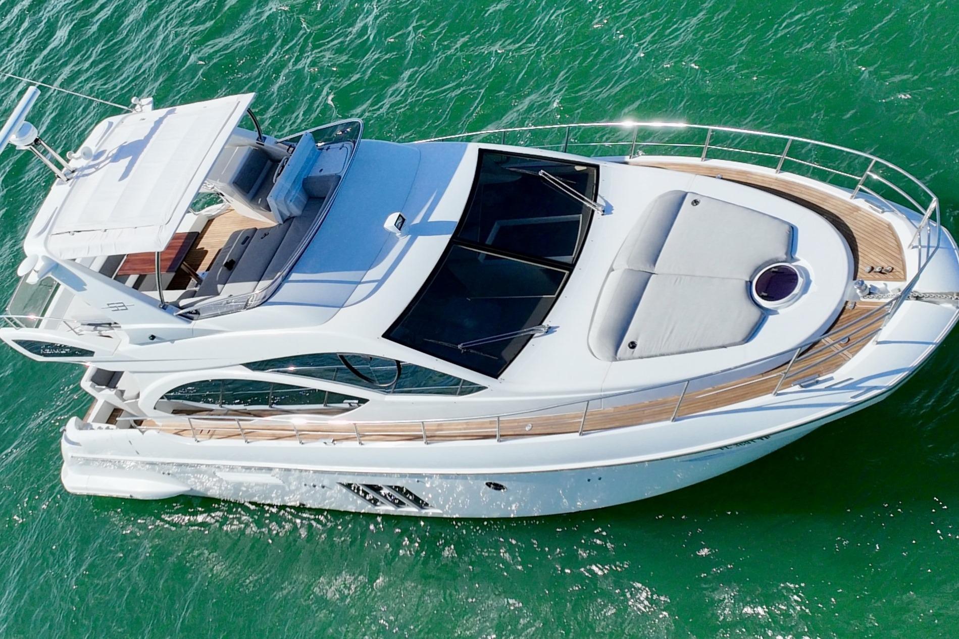 2013 Azimut Fly 53 yacht cruising on vibrant green waters.