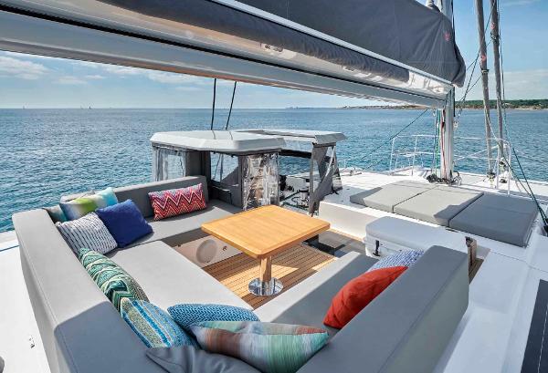 Luxury Privilege Signature 580 yacht deck with seating, colorful cushions, and ocean view, 2025 model.