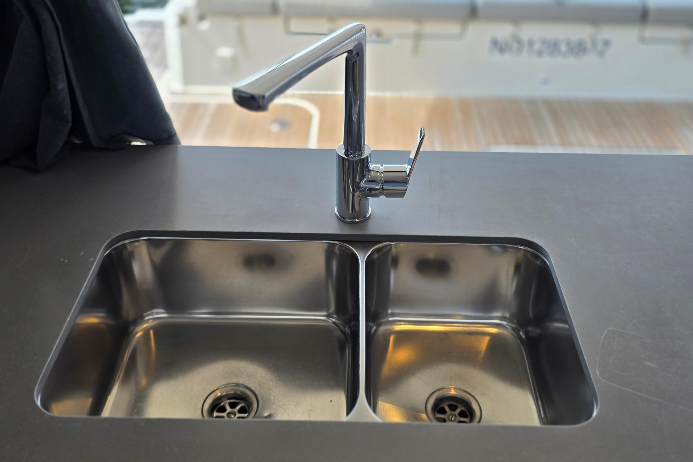 Stainless steel double sink with modern faucet on 2018 Fountaine Pajot Motor Yacht 44.