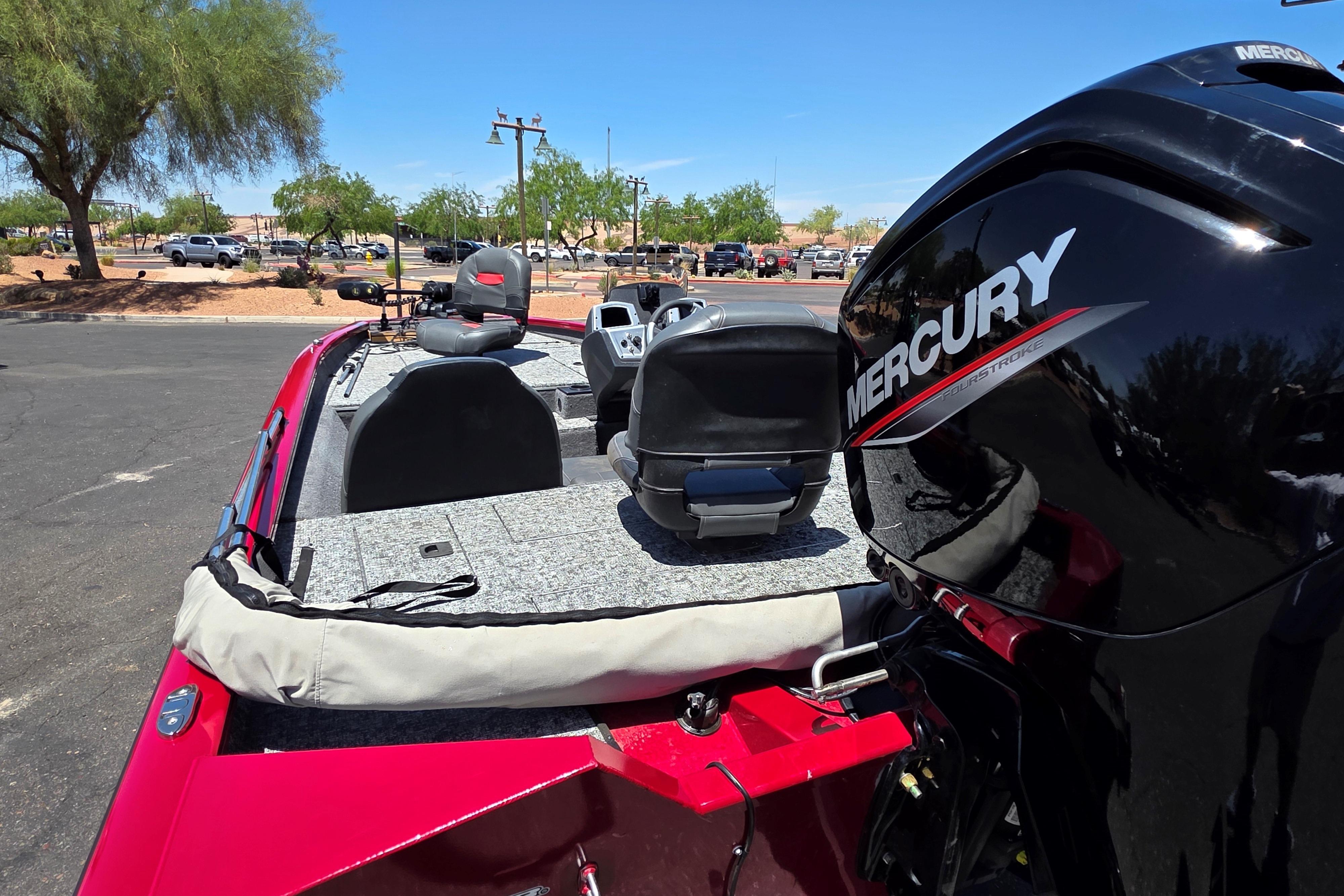 2025 Tracker Pro Team 175 boat with Mercury engine, parked outdoors on a sunny day.