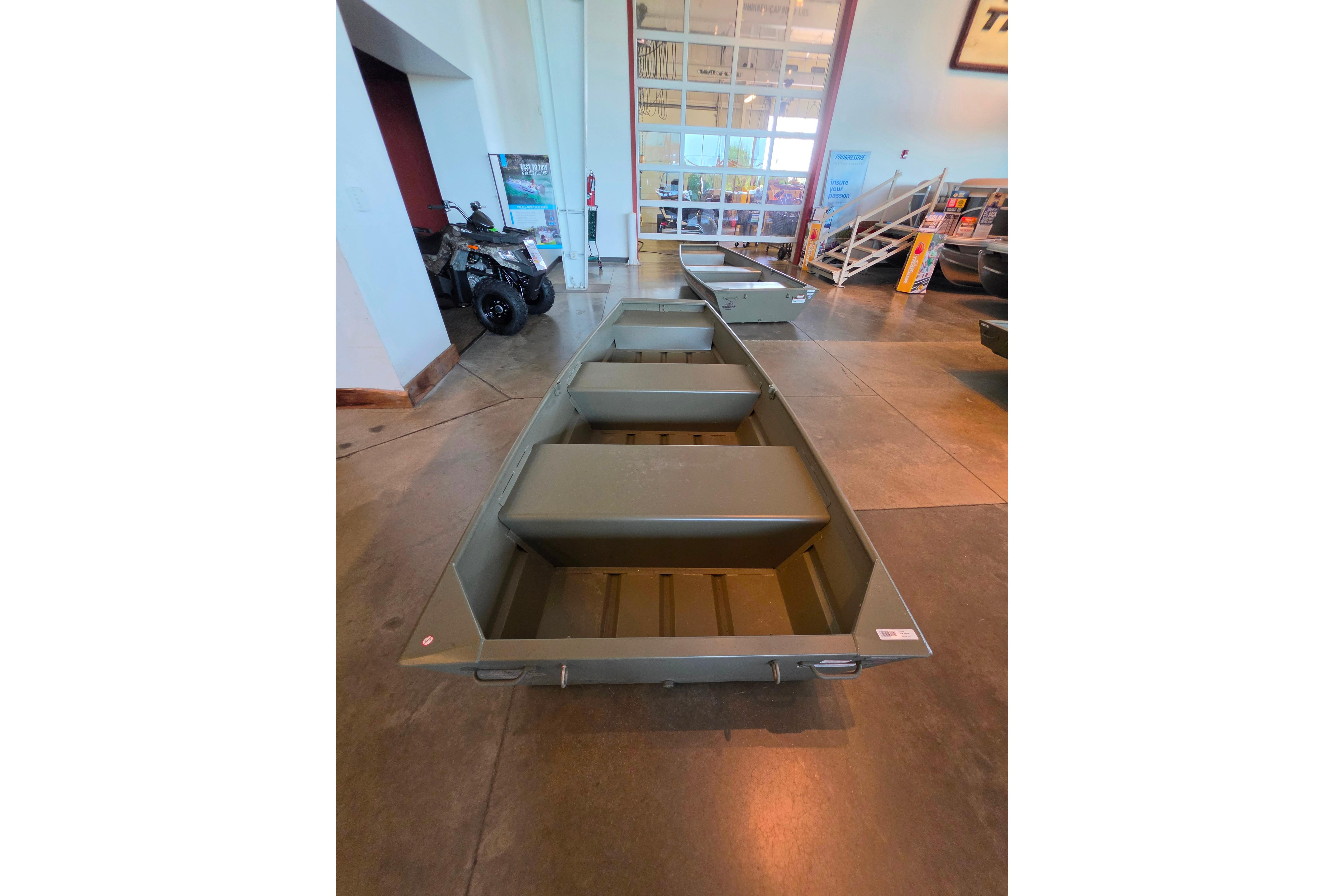 2026 Tracker Grizzly 10 Jon boat displayed indoors, showcasing its sturdy design and spacious interior.