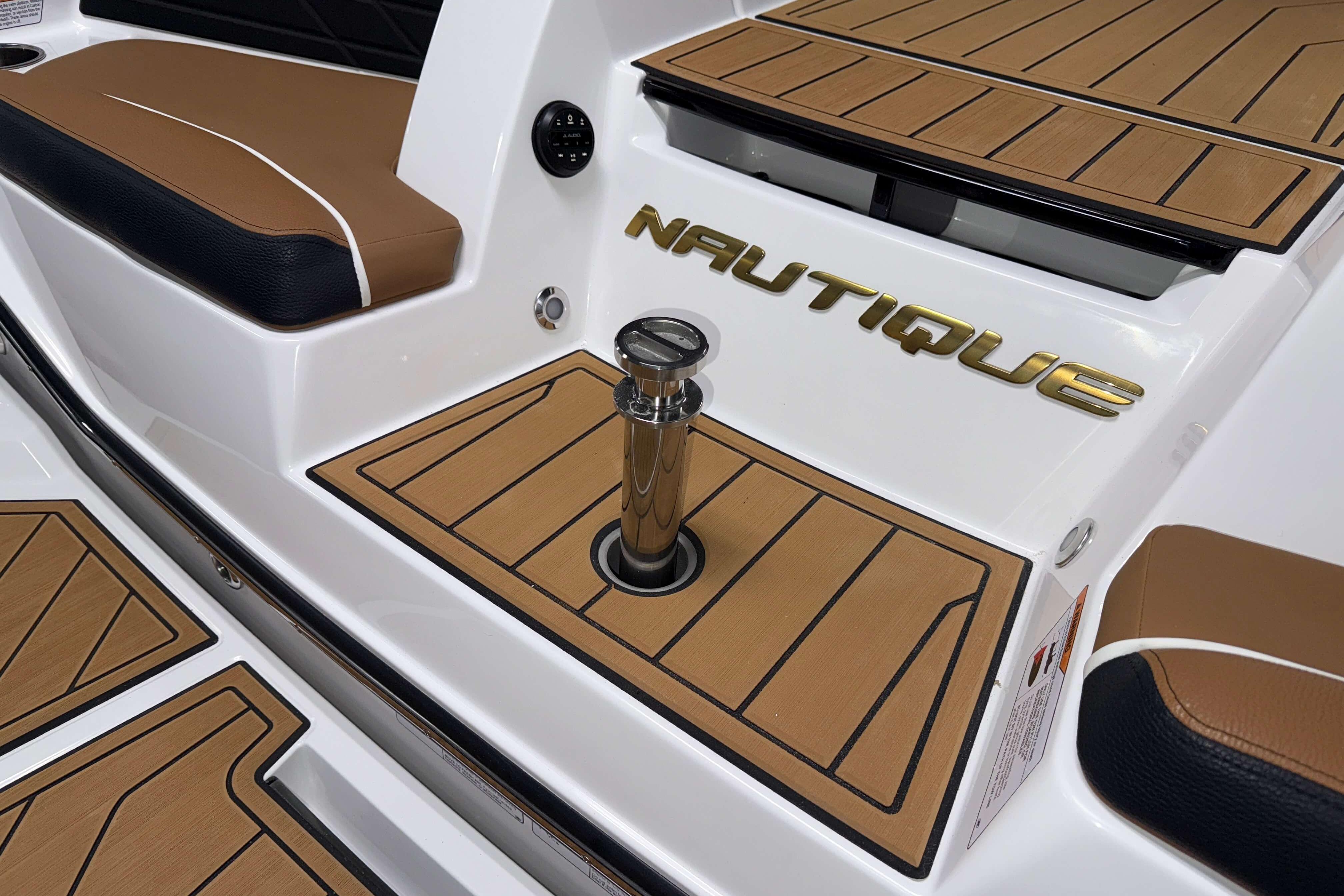 2026 Nautique Super Air Nautique S23 boat interior with teak flooring and branded detailing.