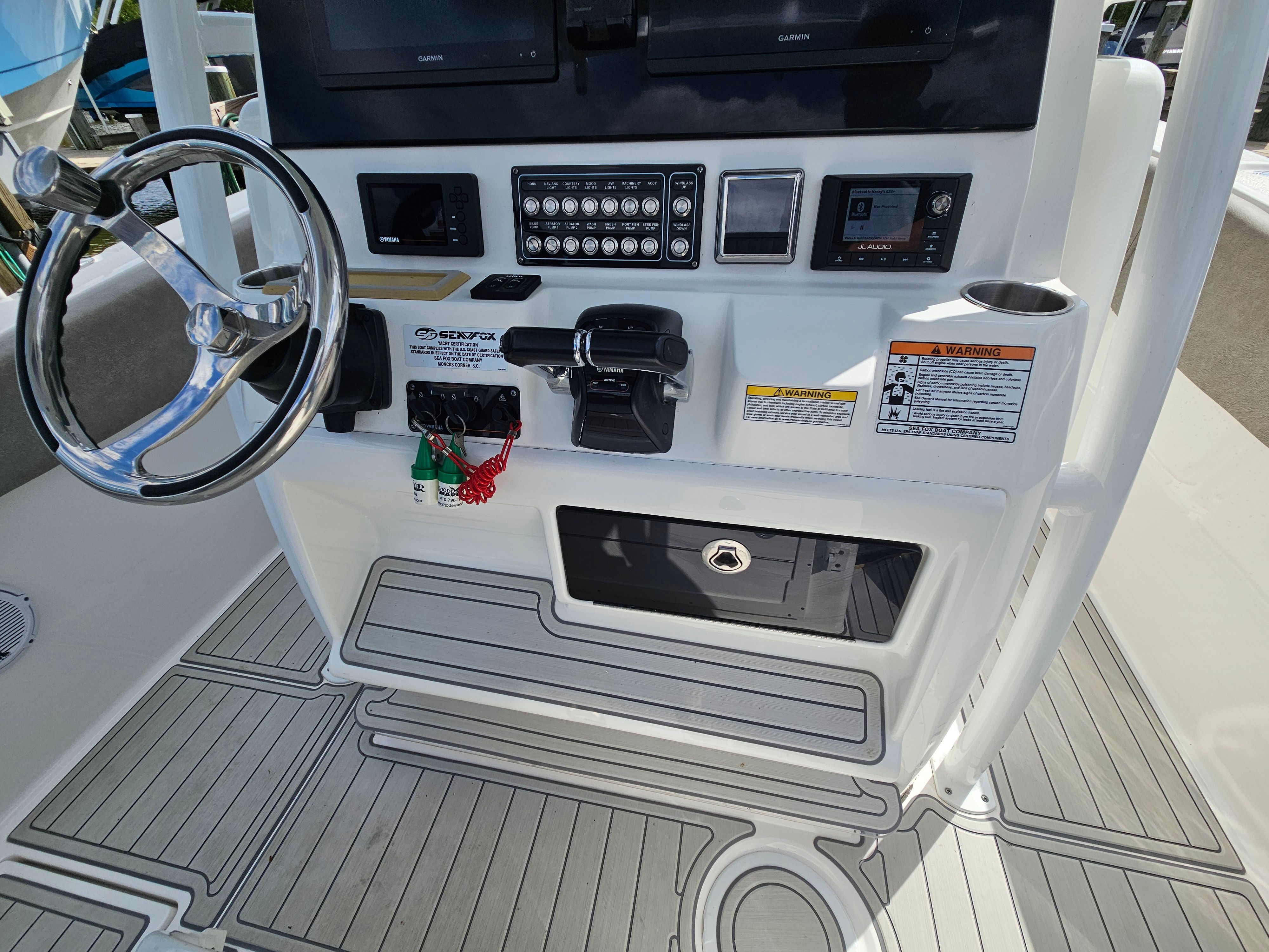 2021 Sea Fox 288 Commander helm with controls and steering wheel.