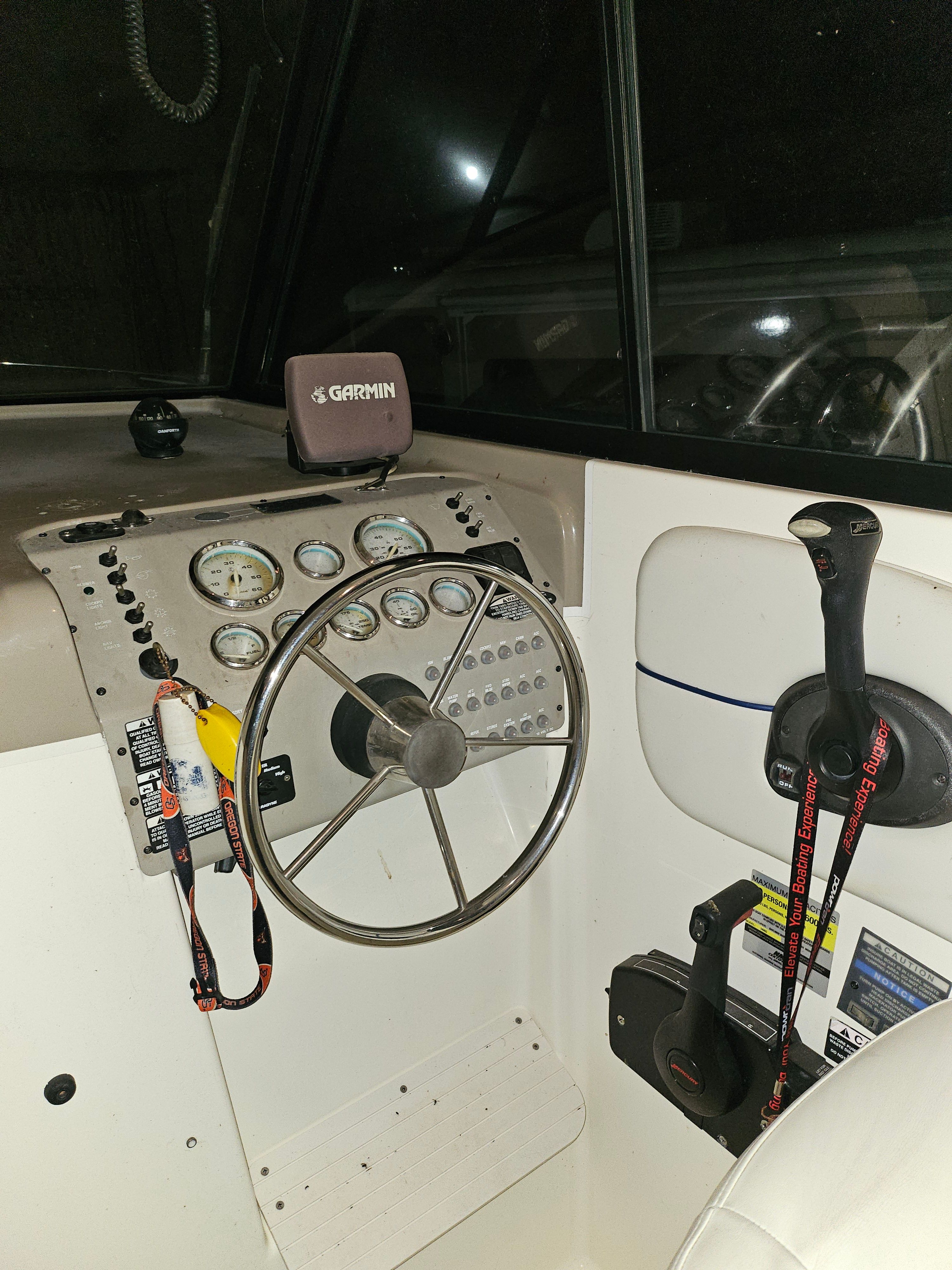 Helm of a 2005 Bayliner 242 Ceara with Garmin device and instruments.