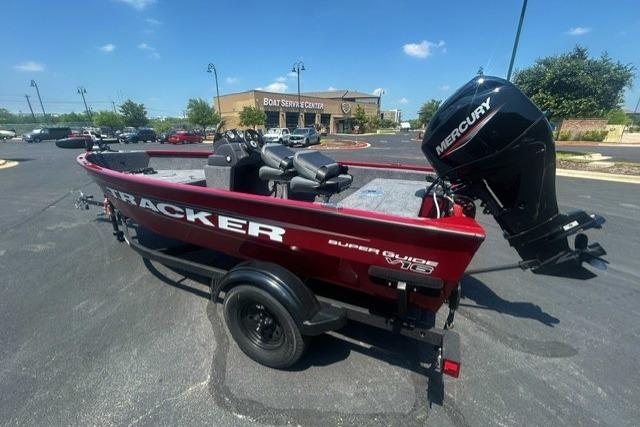 2026 Tracker Super Guide V-16 SC boat with Mercury engine in parking lot.
