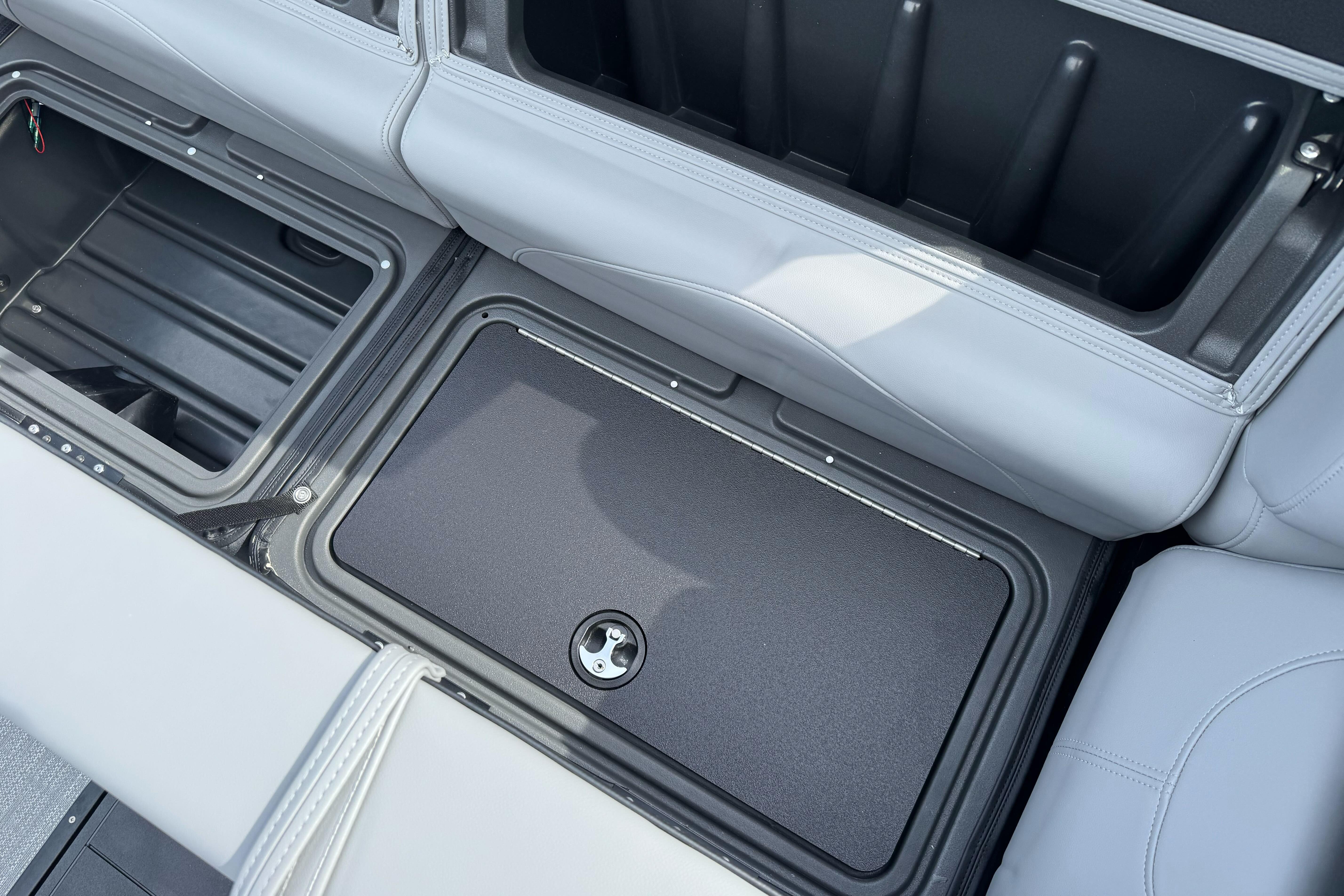 2026 Regency 250 DL boat storage compartment with open and closed sections.