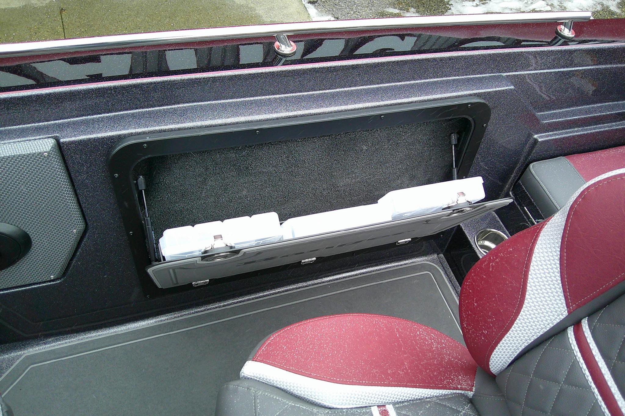 2026 Ranger 620xFS Pro boat interior with storage compartment and red seats.