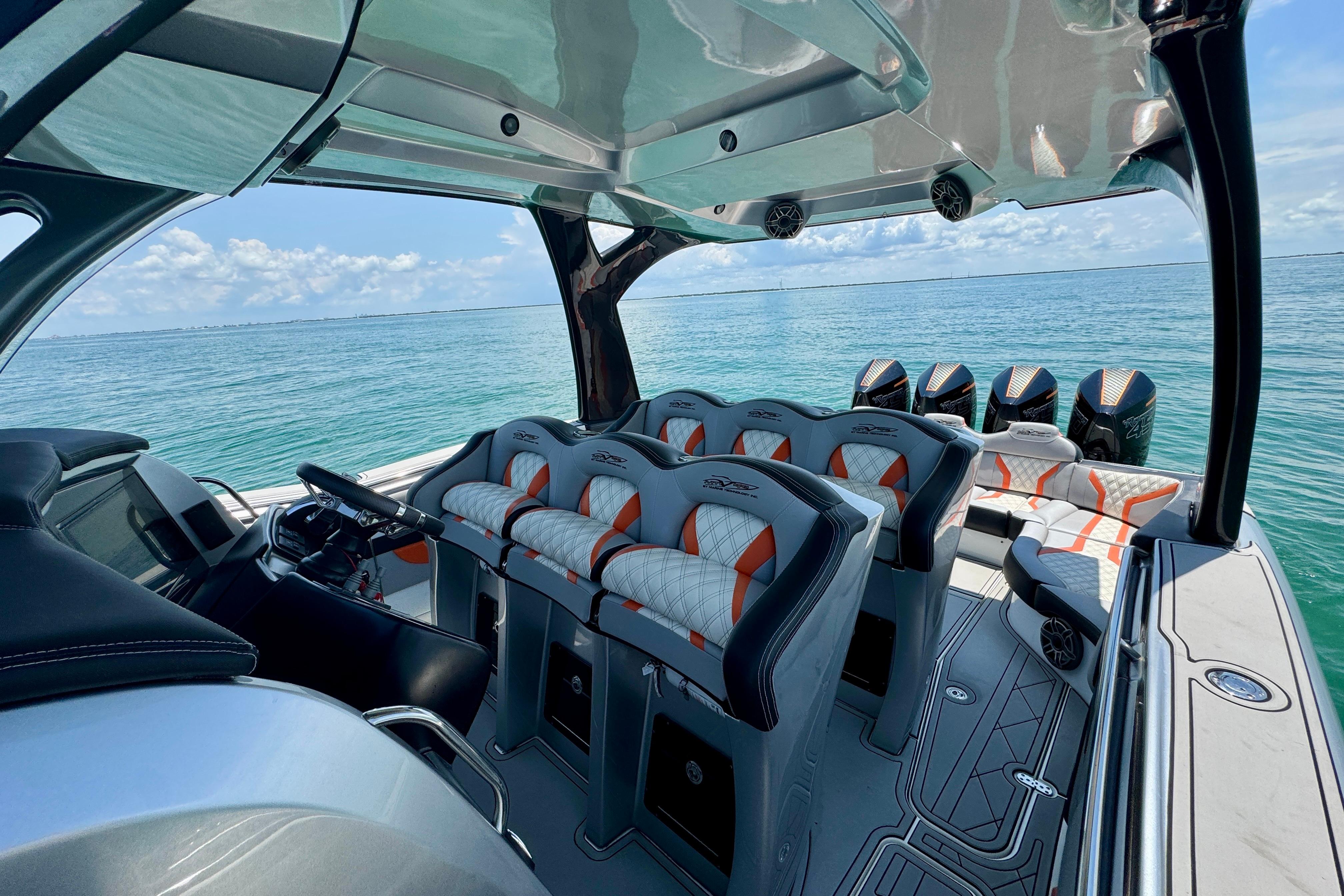 Luxury MTI V42 boat interior with plush seating, overlooking serene ocean waters.
