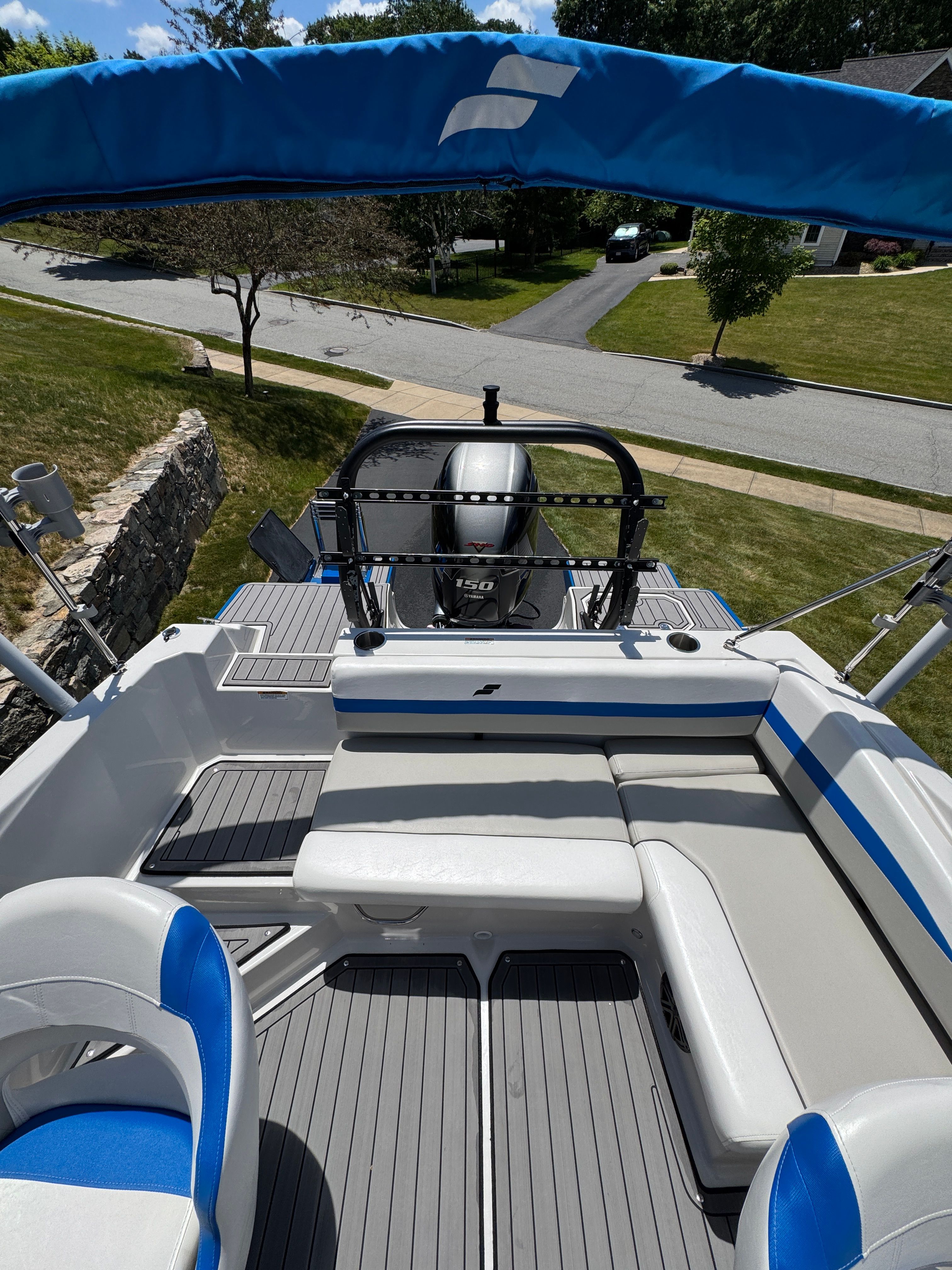 2023 Starcraft SVX 190 OB boat with blue canopy and gray deck.