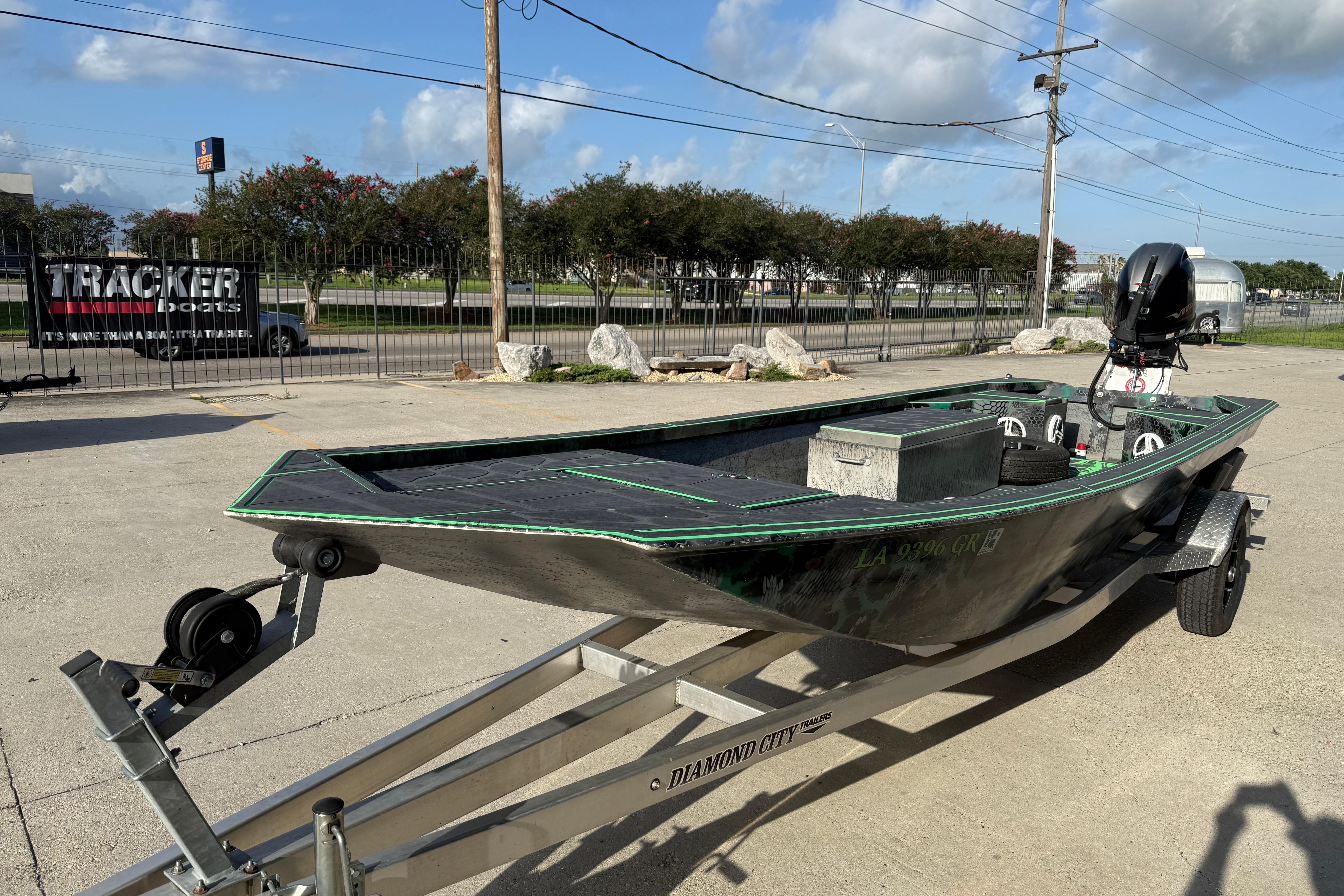 Custom Rene Gros 20x48 boat on trailer, 2024 model, parked outdoors under clear sky.