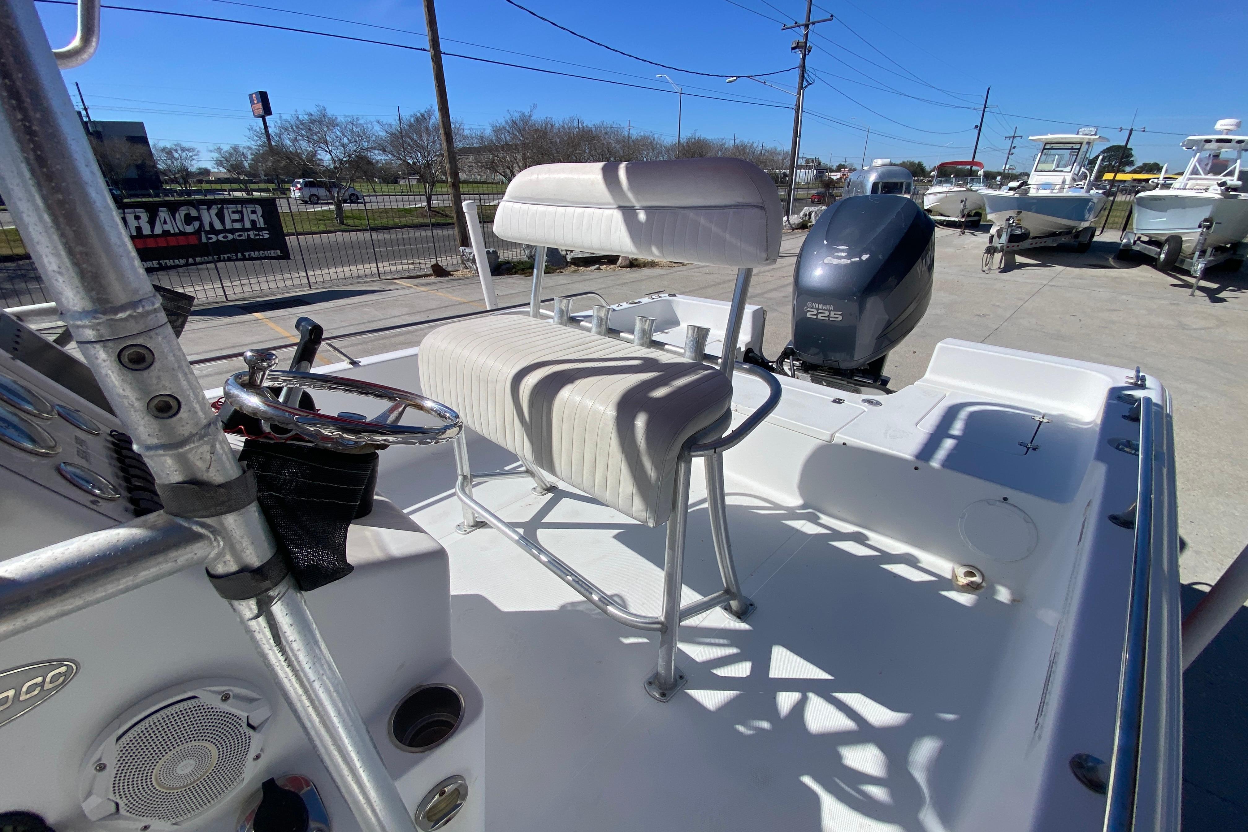 2005 Sea Pro SV2400CC Bay Boat interior with Yamaha 225 engine, docked outdoors.