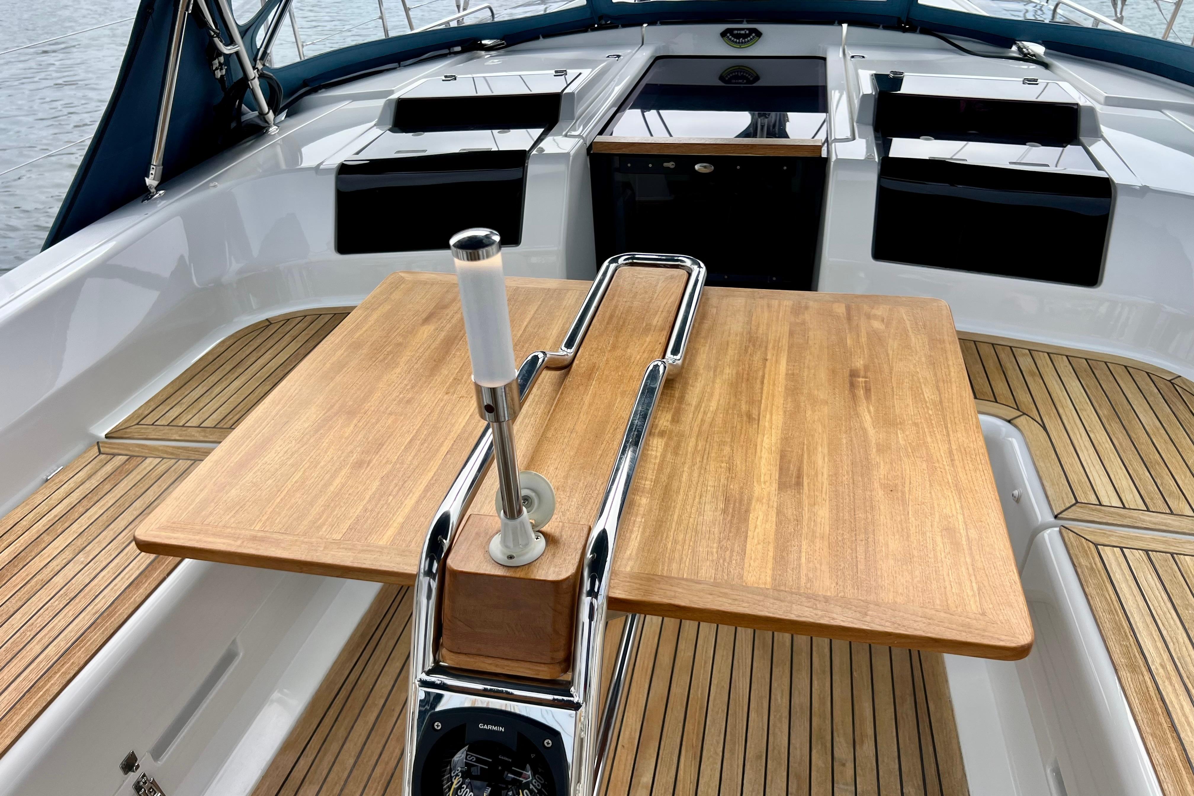 Cockpit of 2016 Hanse 455 yacht with wooden table and sleek design.