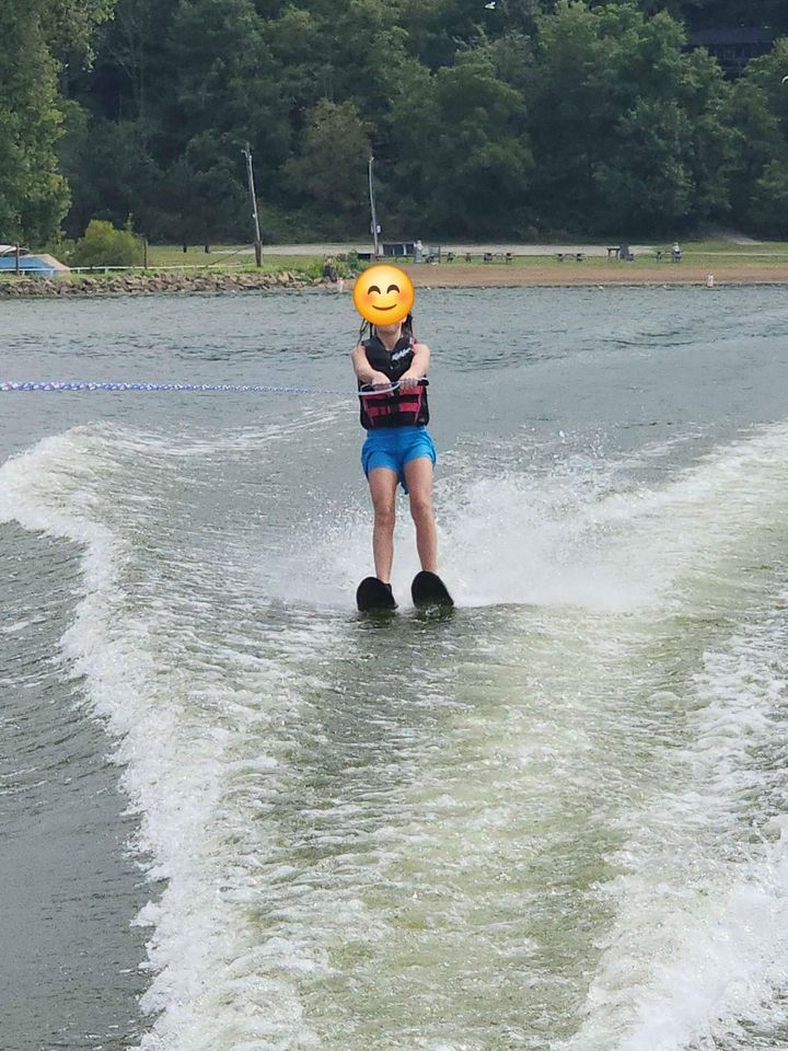 Person waterskiing behind a Campion Explorer 542 Sport Cabin.